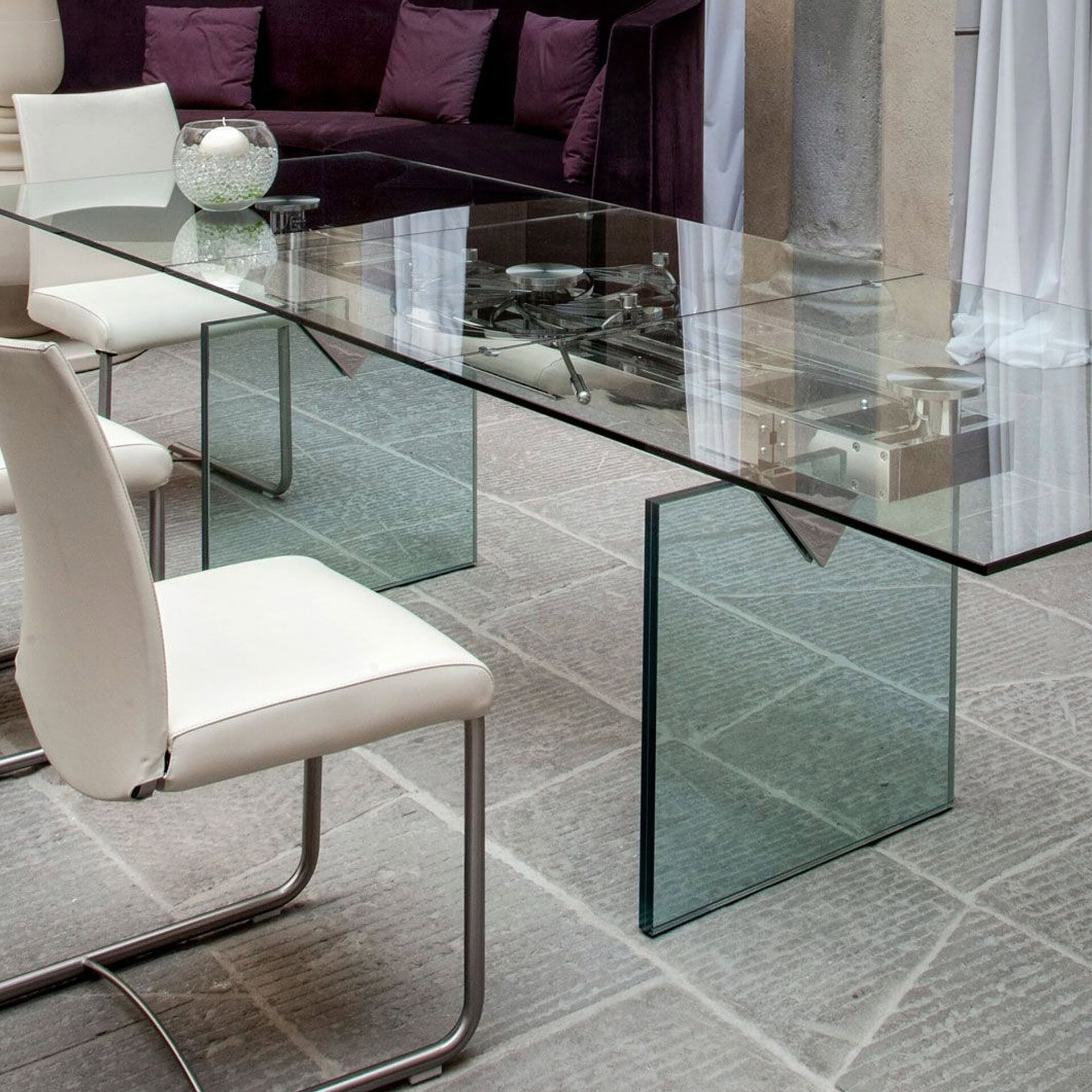 Detail view of Quasar Extendable Dining Table with glass legs in a modern dining space