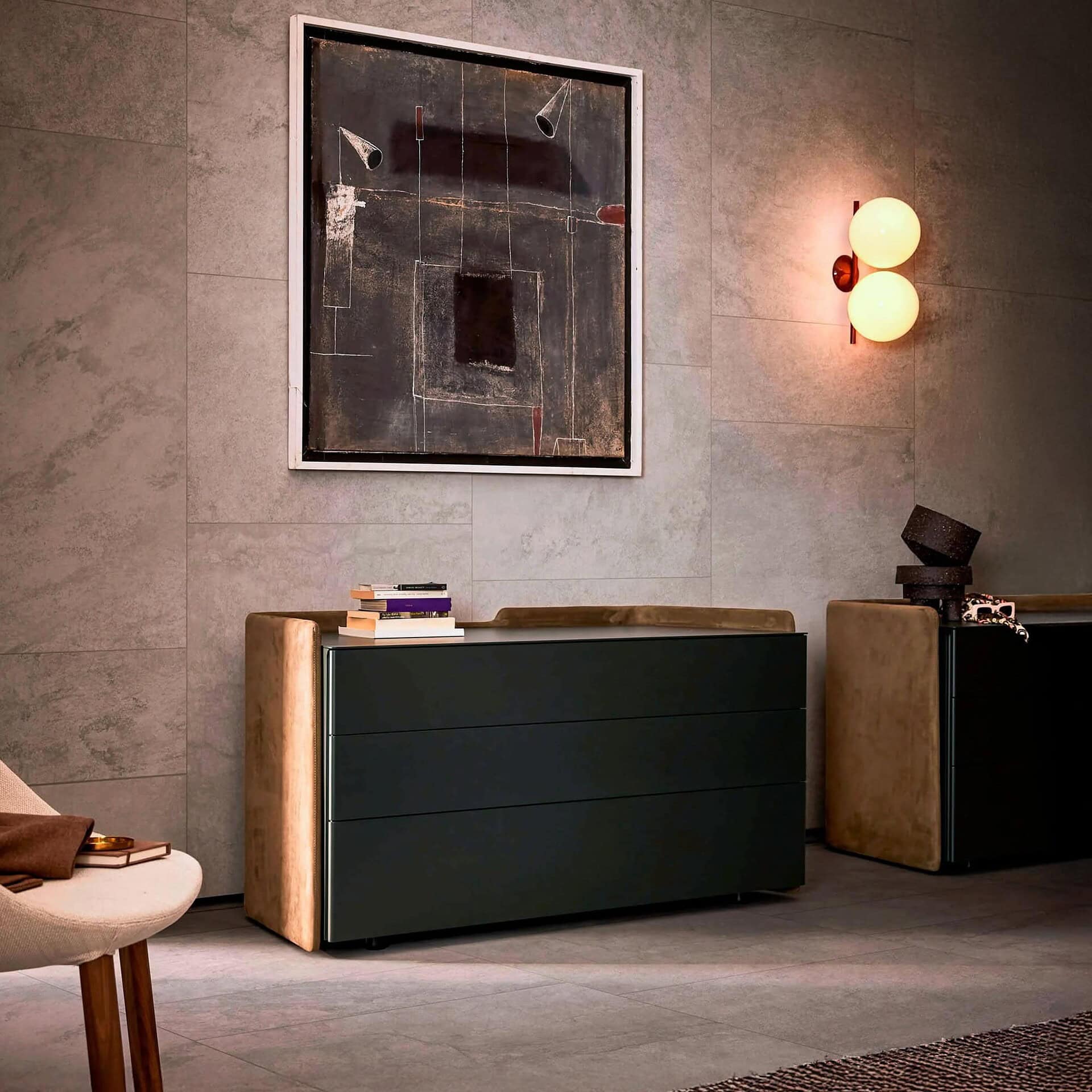 Chloé Upholstered Modern Dresser in deep green finish styled with wall sconce and side table.