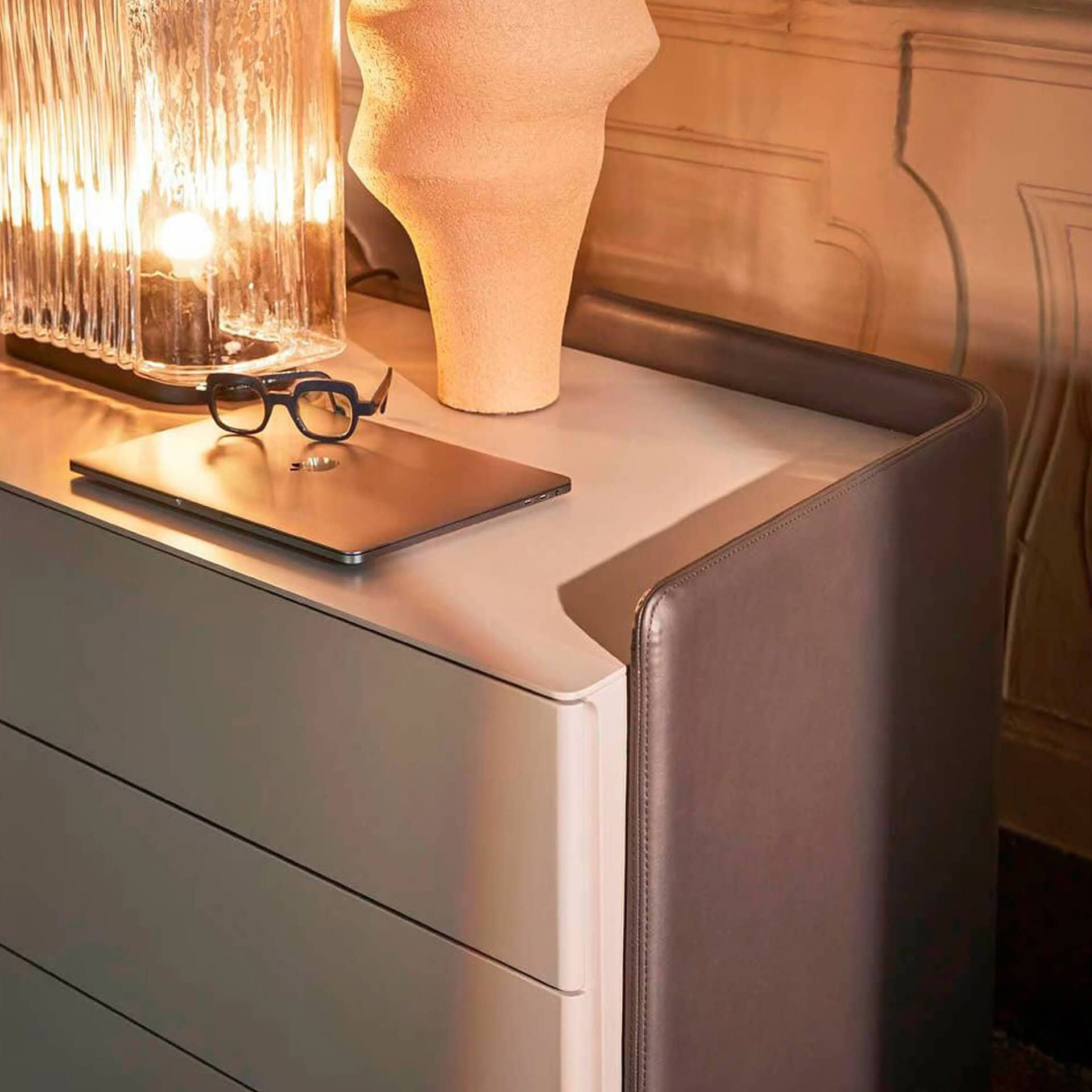 Detail of Chloé Upholstered Modern Dresser top with decorative lamp and soft curved edges.