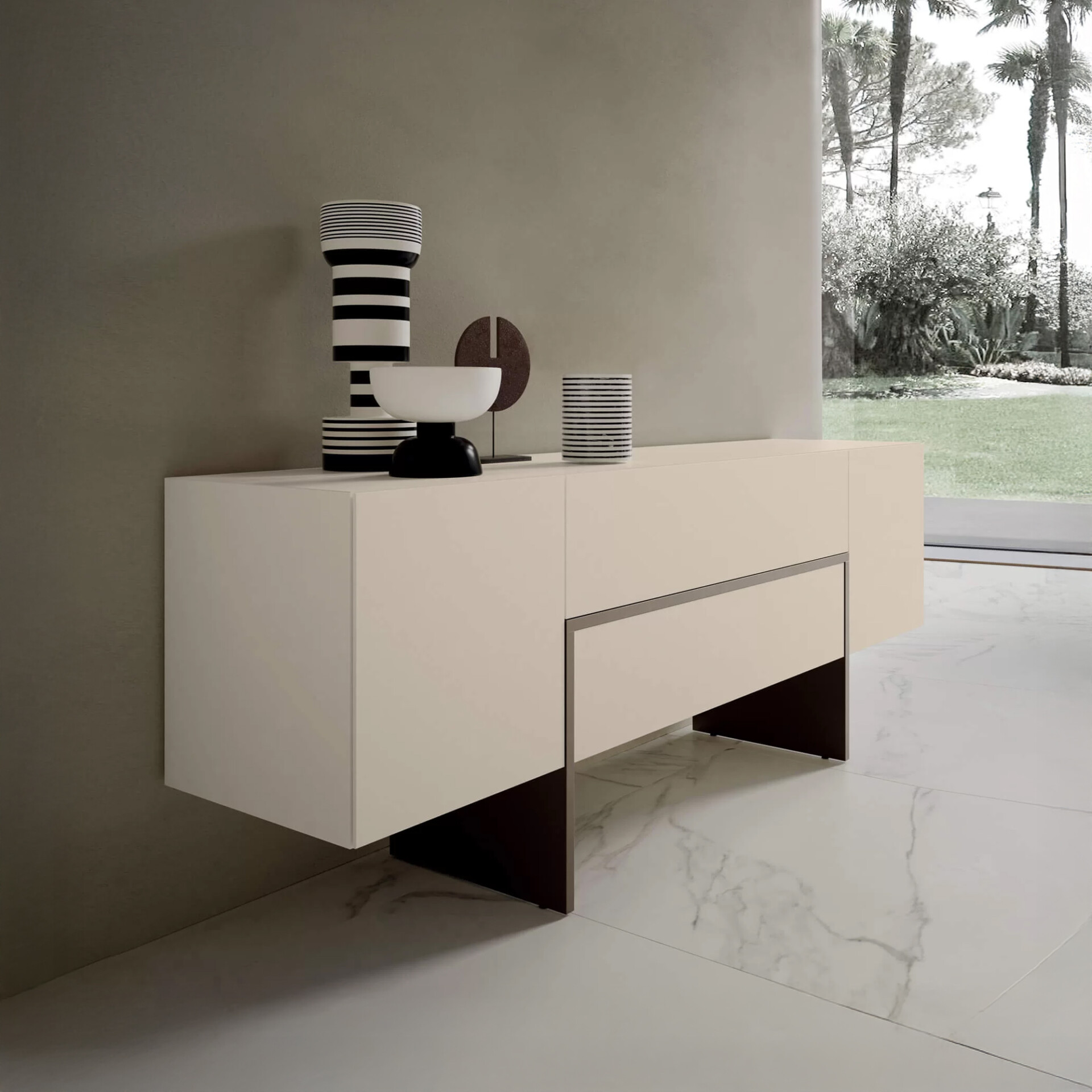 A modern light beige sideboard with black and white striped decor against a grey wall, overlooking a lush garden with palm trees through a large window.