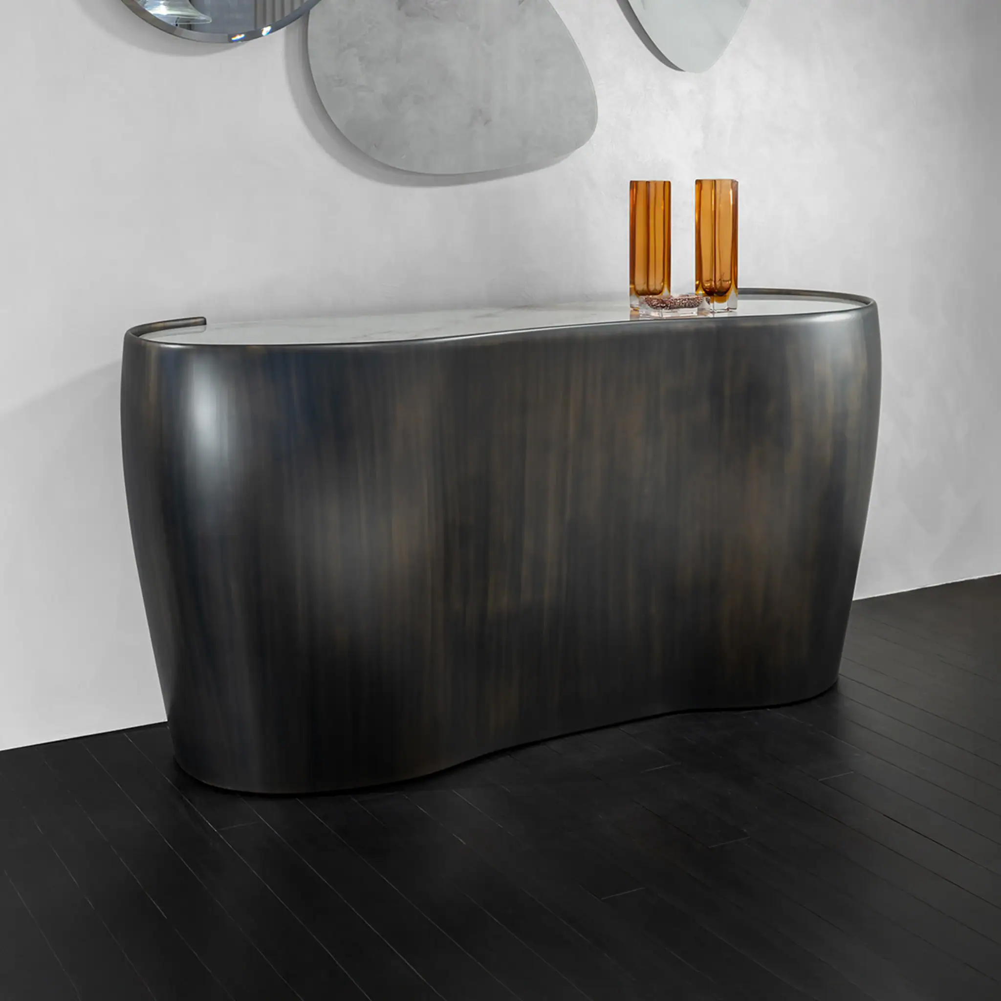 Contemporary black console table with a curved design and wooden accents on top.