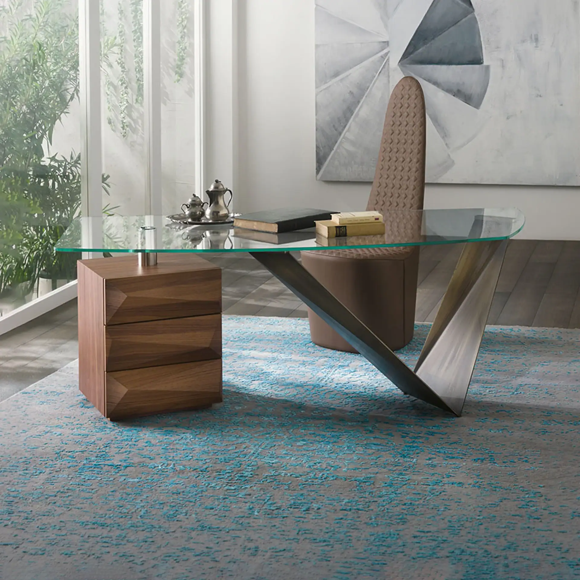 Modern glass desk with unique steel base in contemporary office setting.