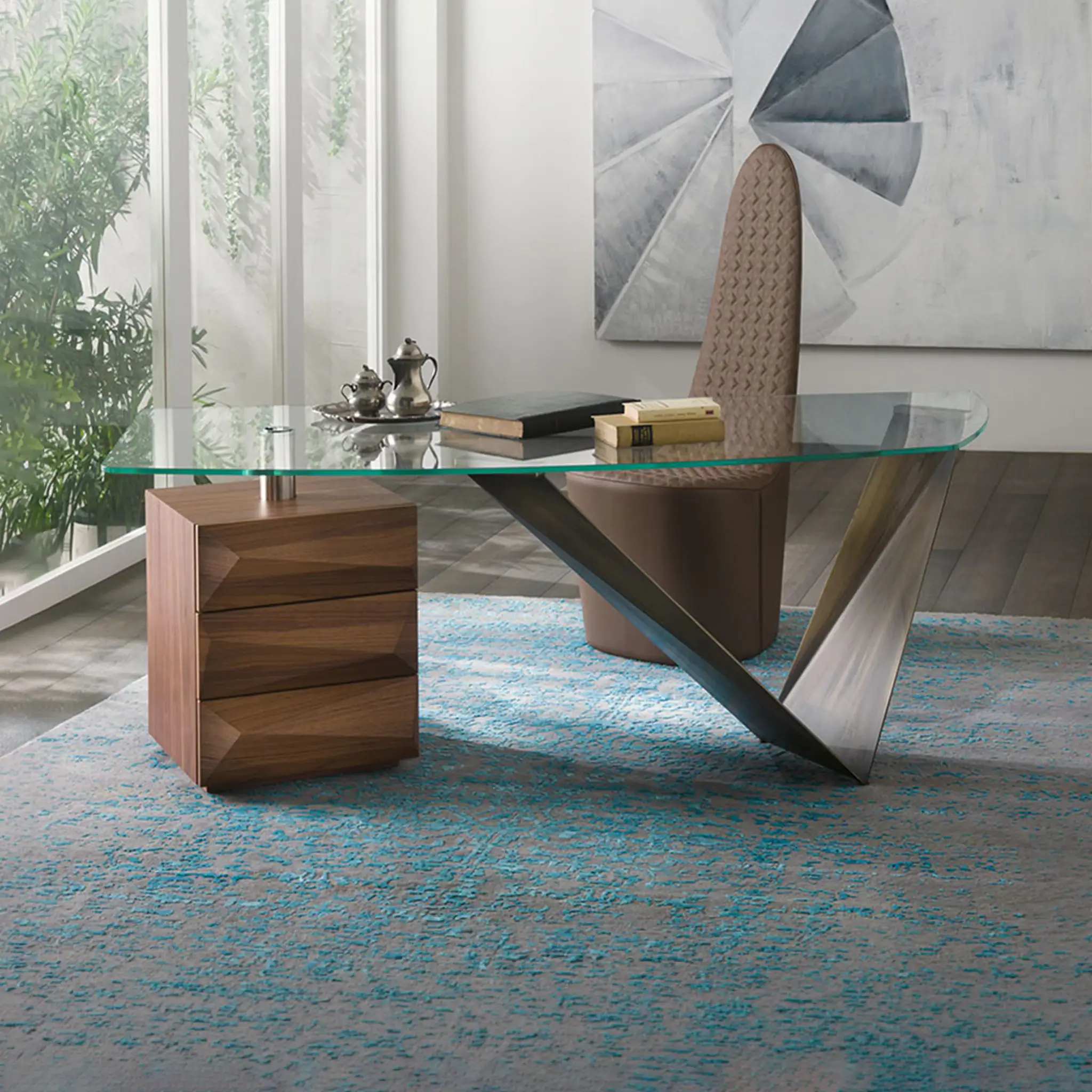 Modern glass desk with unique steel base in contemporary office setting.