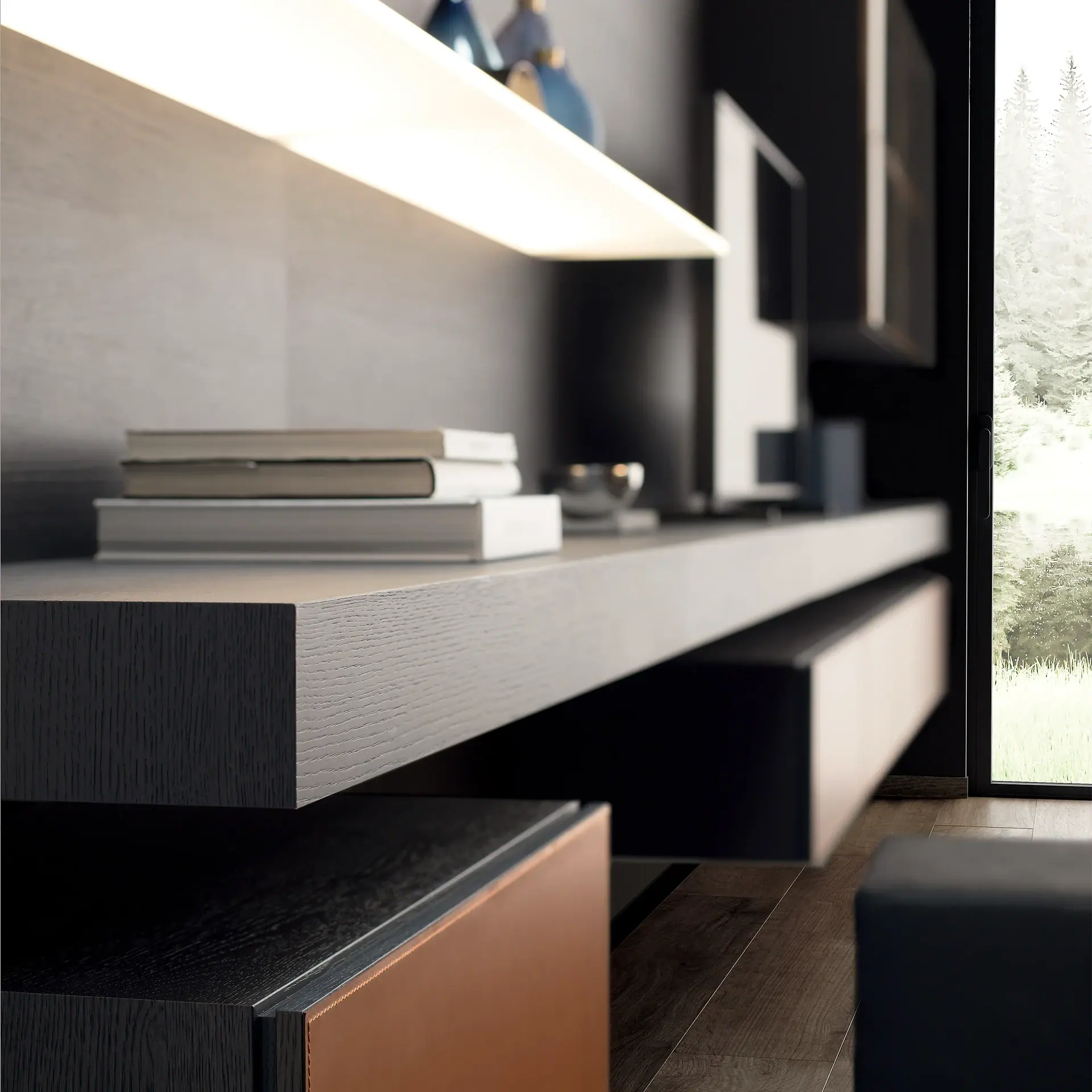 A modern living room with a dark wood floating console, illuminated shelf, stacked books, and a window looking out to trees and grass.