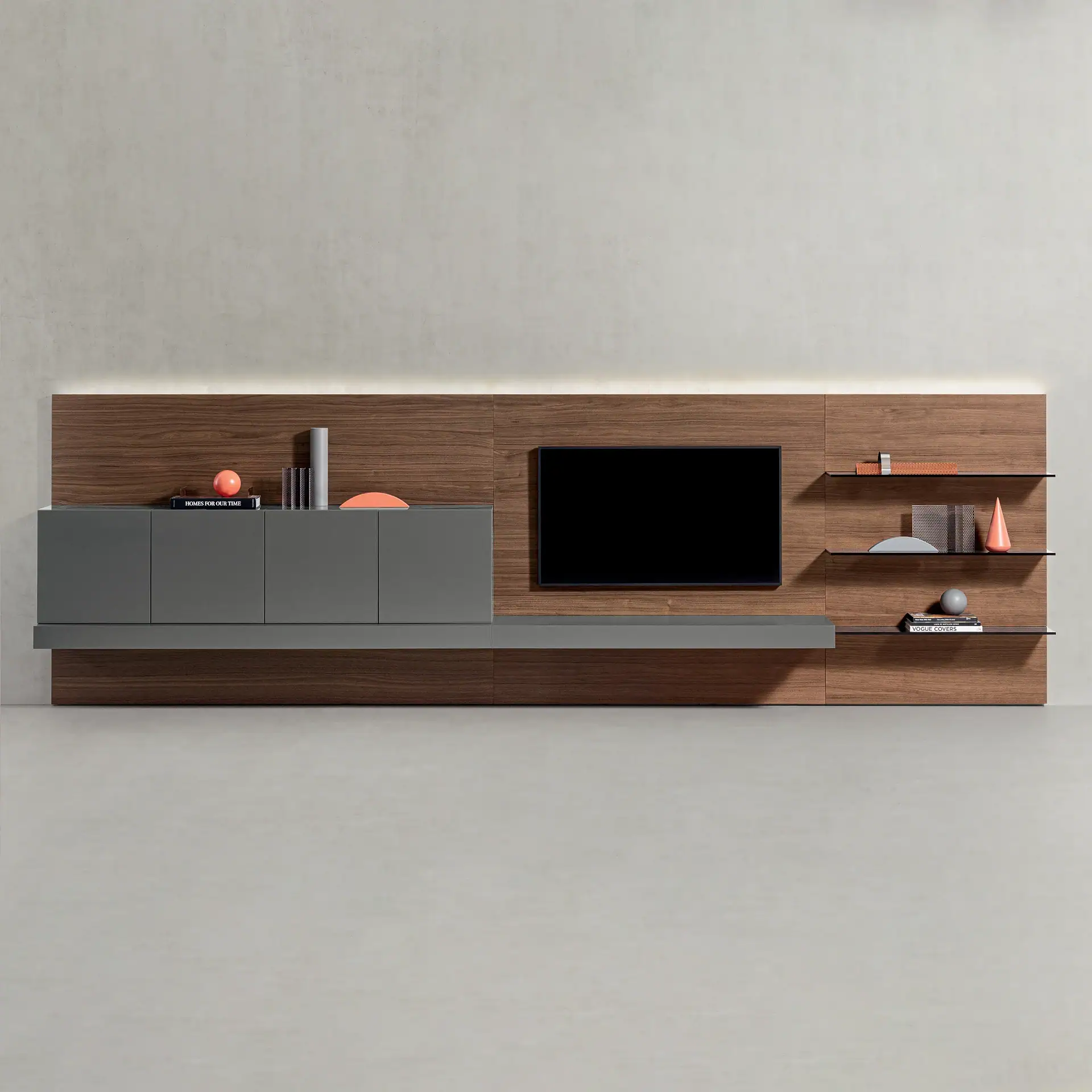 Modern wall-mounted entertainment unit with dark wood paneling, gray cabinets, a black TV, and decorative objects on glass shelves, set against a light gray wall.
