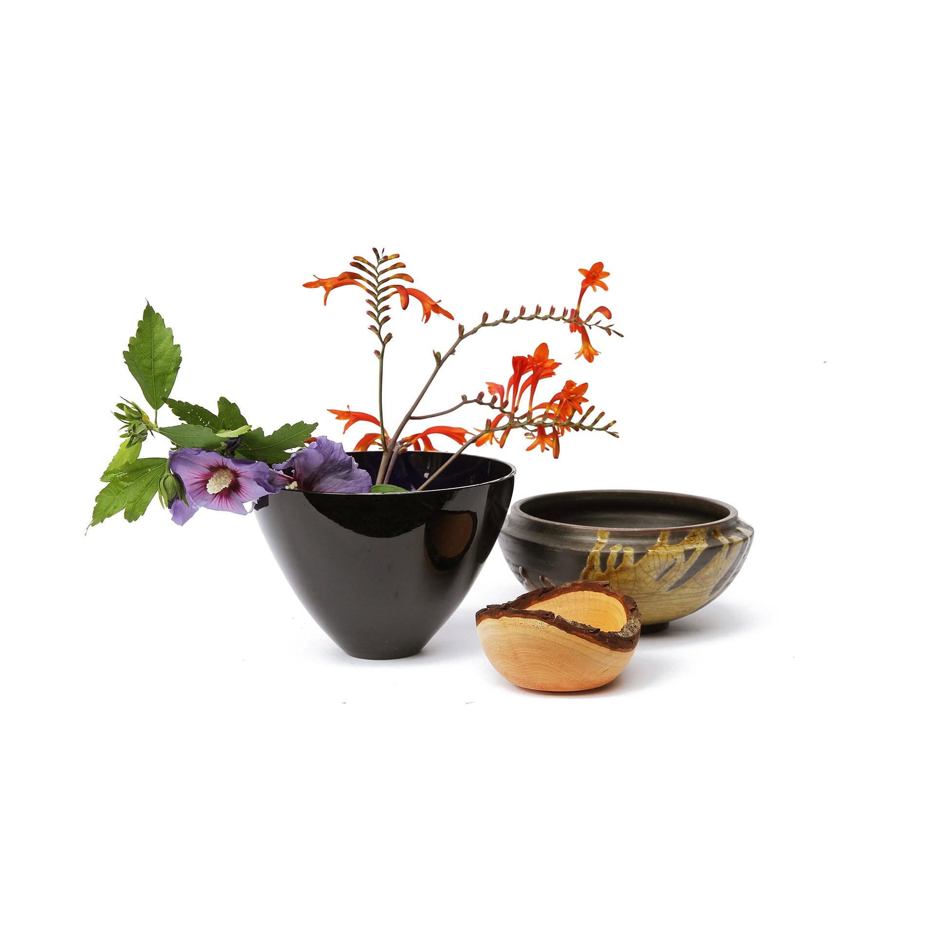 Vase with colorful flowers and wooden bowl, stylish decor from Sklar Furnishings.