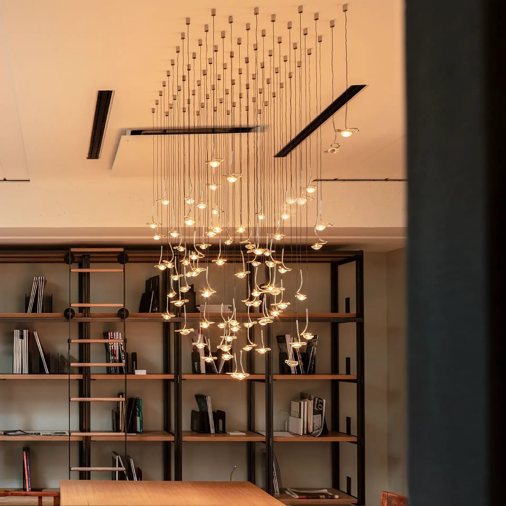 Sklar Furnishings Jackie O Chandelier hanging in a modern room.
