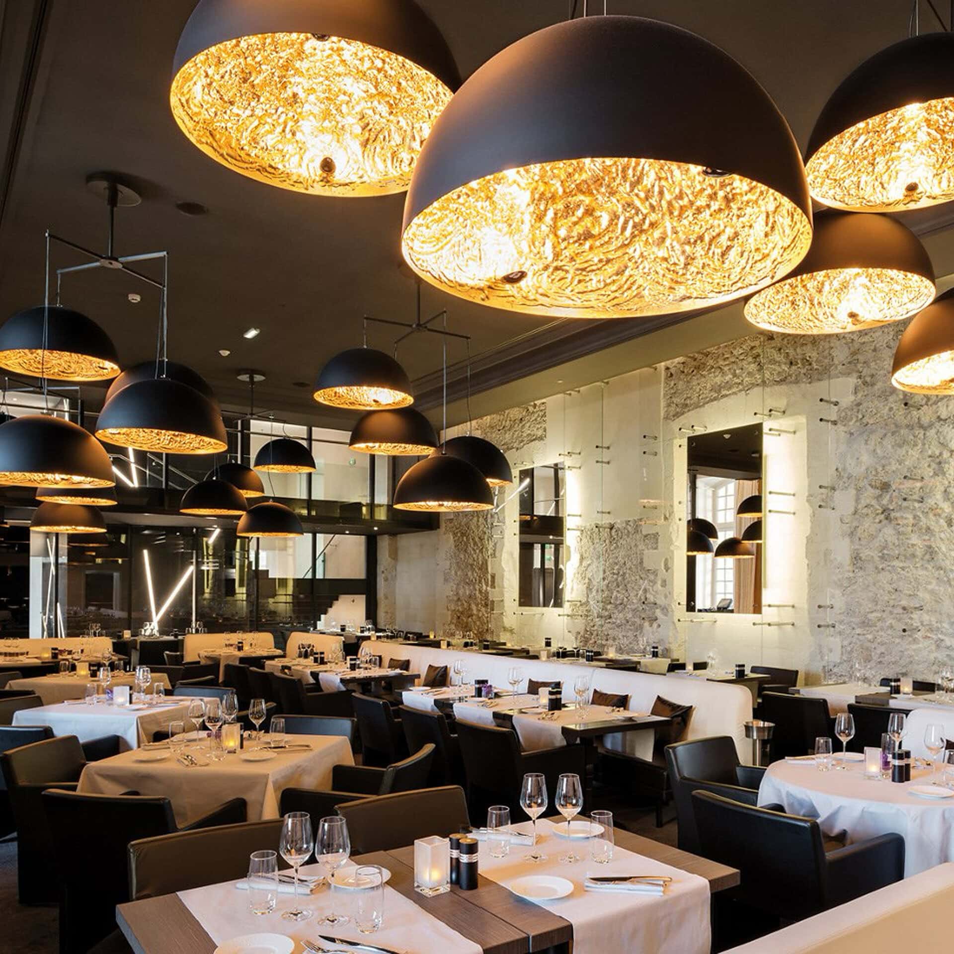 Elegant Stchu-Moon chandelier enhances contemporary dining spaces with its unique design.