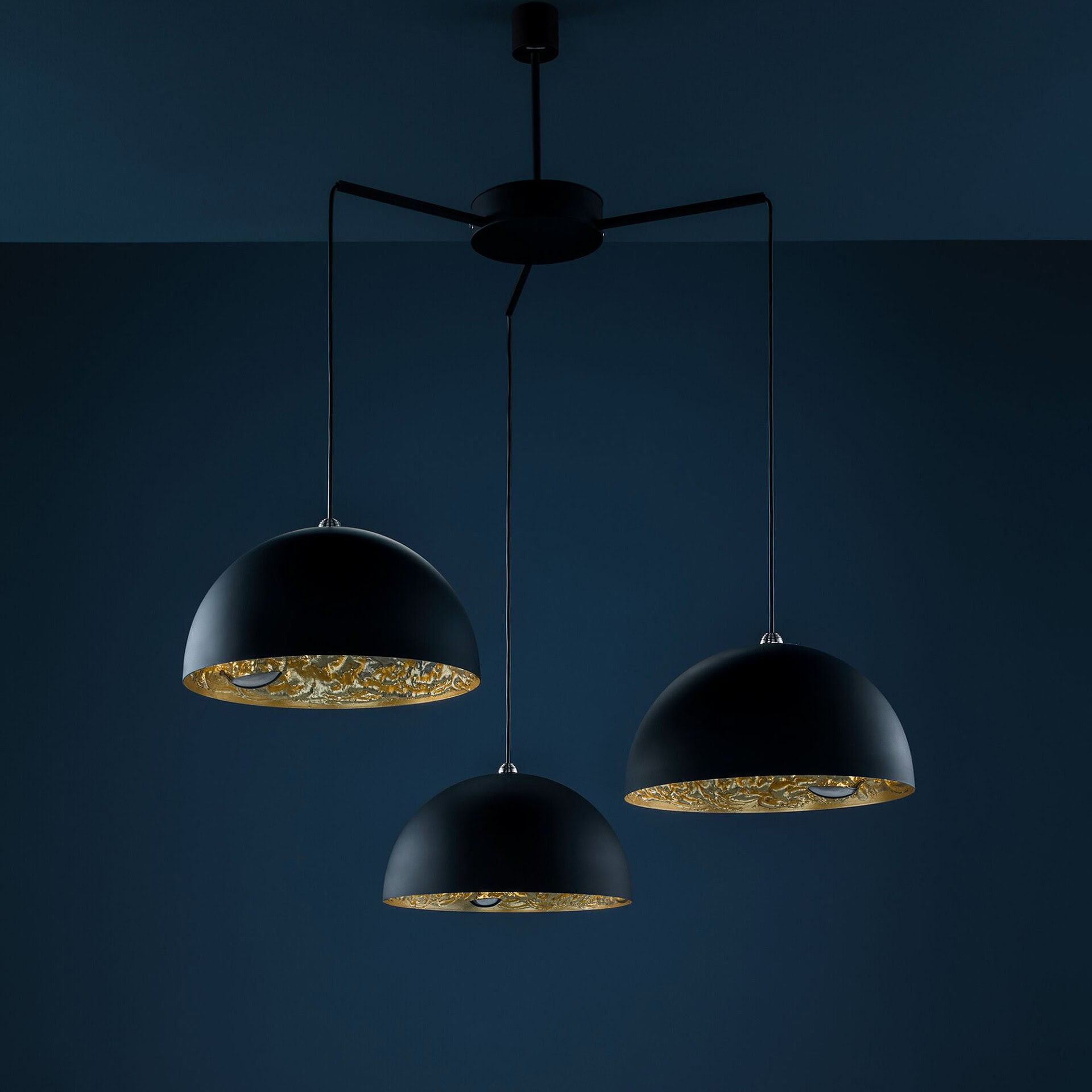 Chic Sklar Furnishings Stchu-Moon modern chandelier featuring black exterior and gold interior accen.