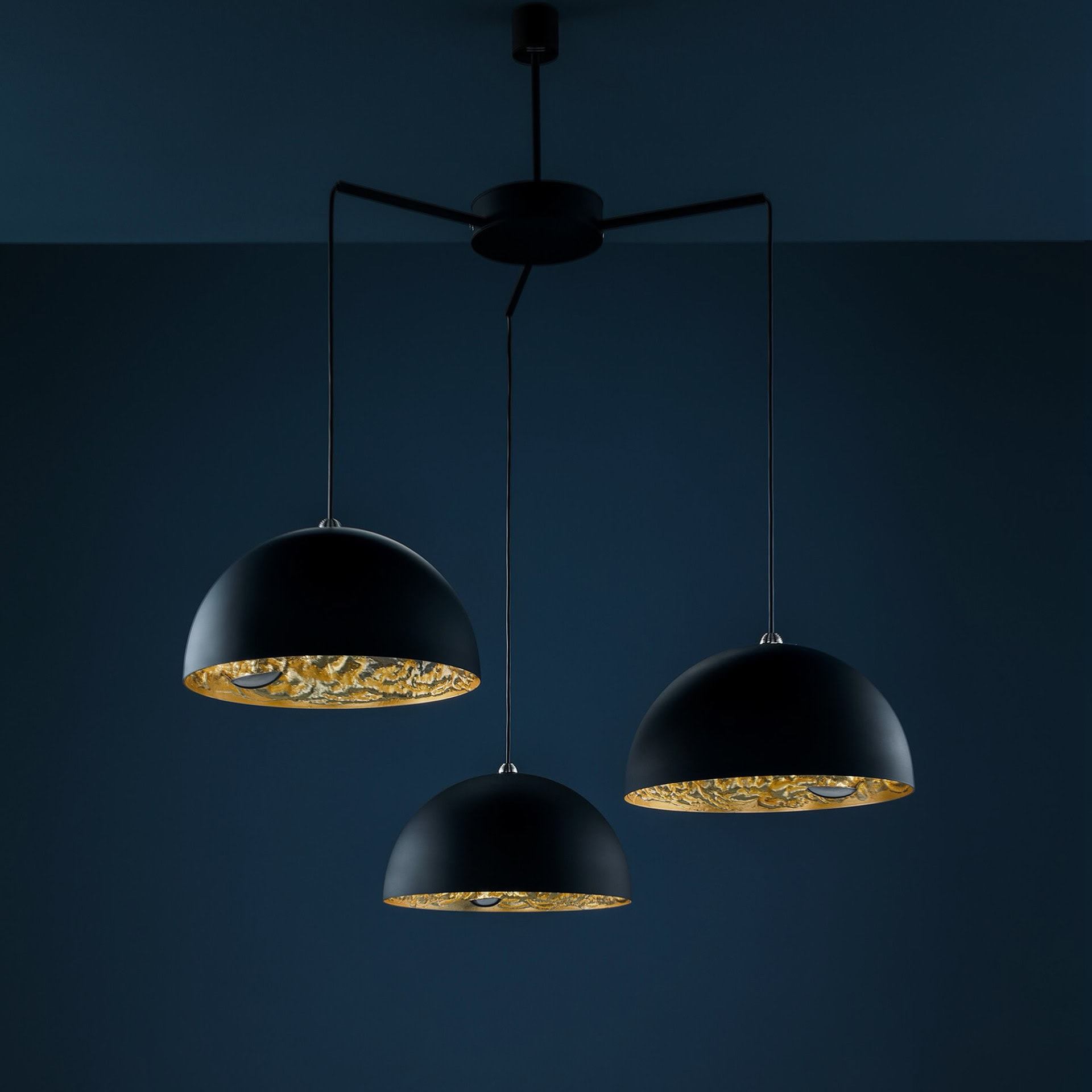 Modern black chandelier with gold interior, stylish lighting for contemporary interiors.