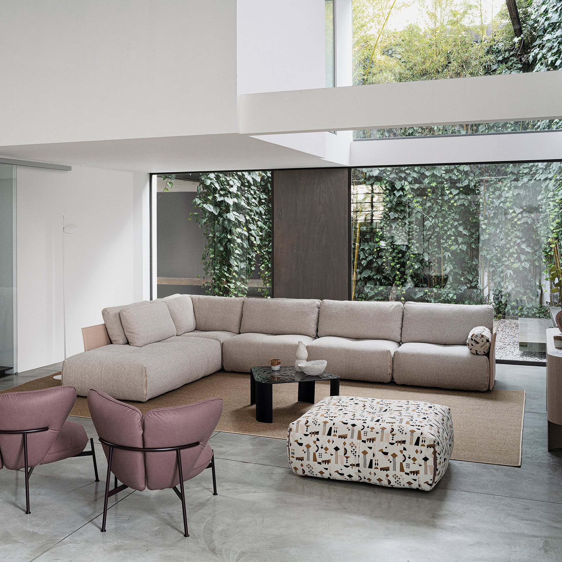 Tab F Sofa in a spacious open-plan living area with light pink accents.