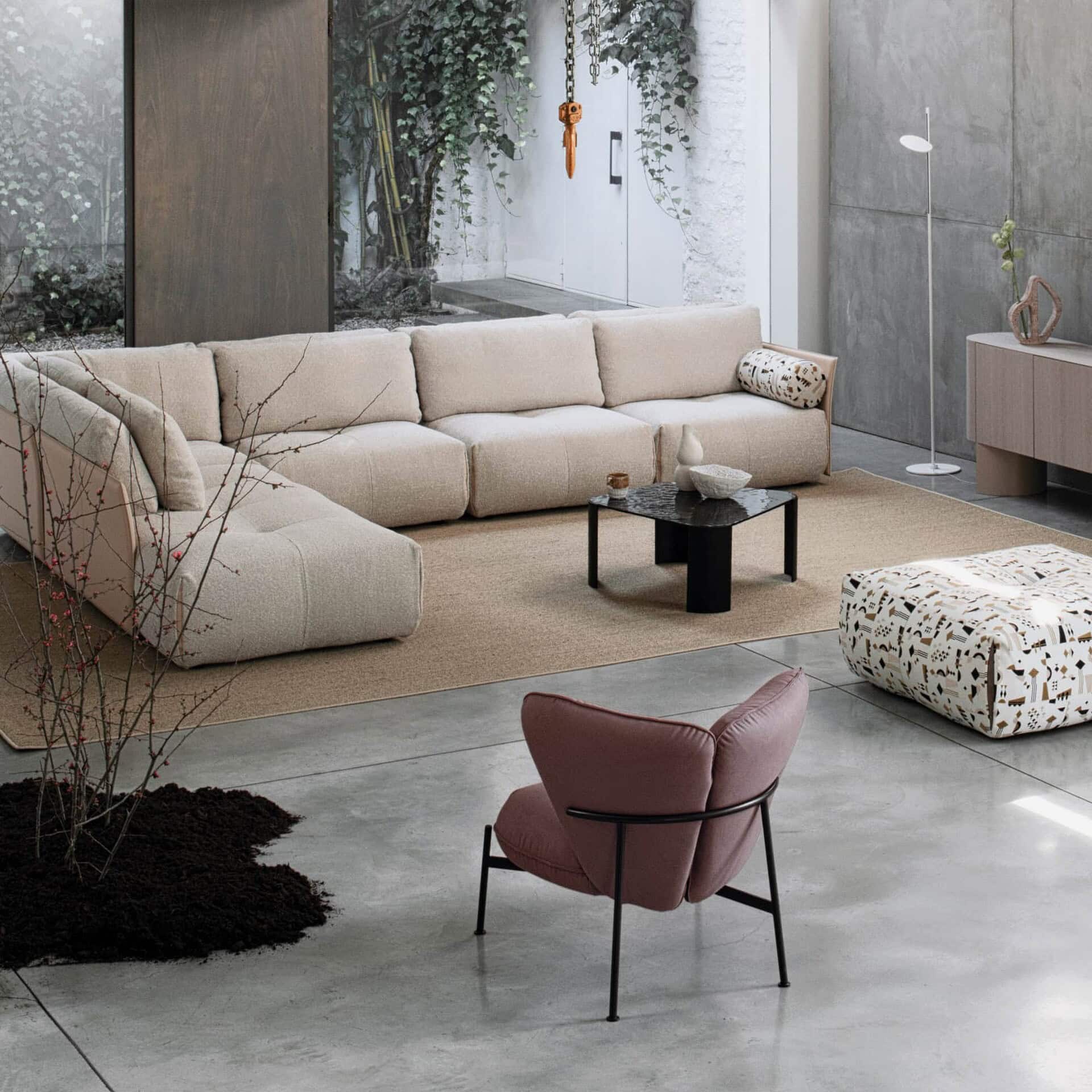 Tab F Sofa in beige fabric upholstery styled in a modern living room with accent tables.