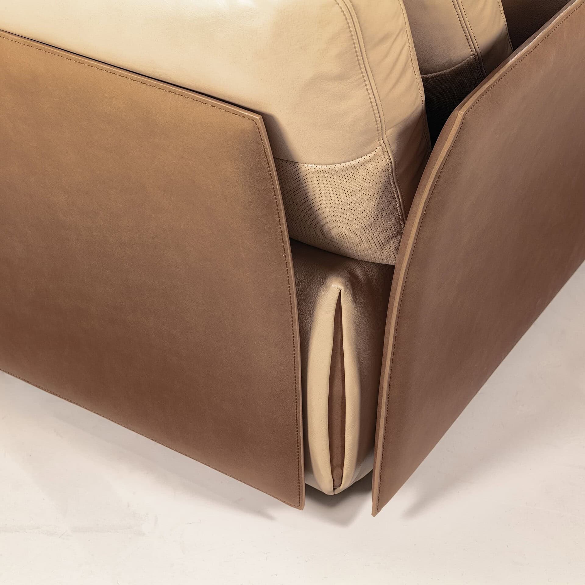 Detail shot of the Tab F Sofa’s leather corner and stitched craftsmanship.