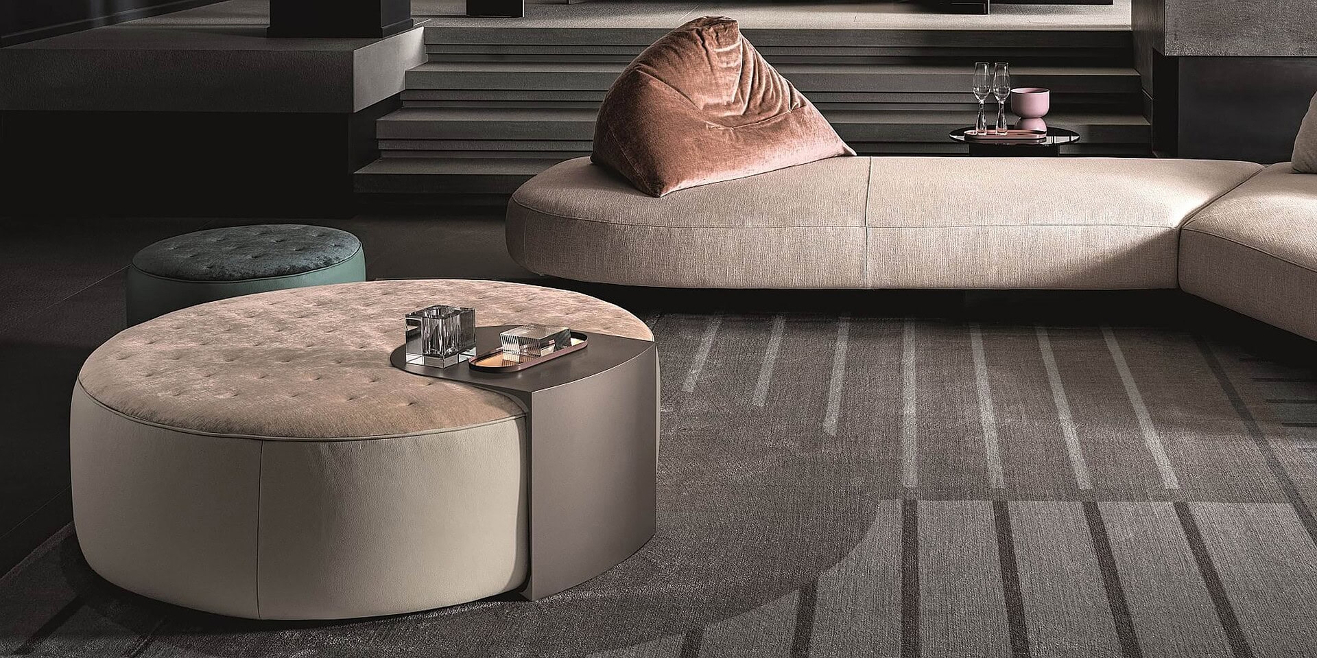 Luxurious modern living room with contemporary sectional sofa and upholstered ottomans.