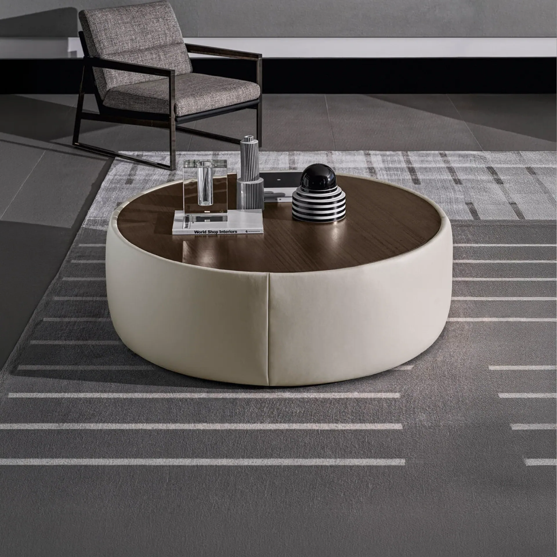 Clip Set Ottoman round coffee table with dark wood top and cream leather base in modern living room.