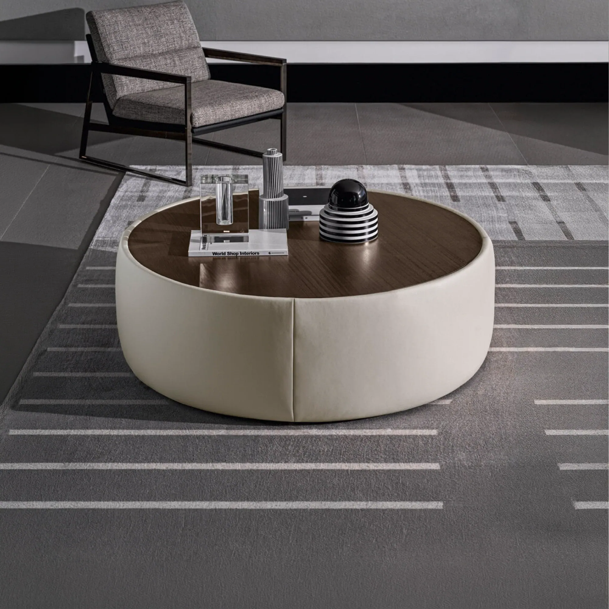 Clip Set Ottoman round coffee table with dark wood top and cream leather base in modern living room.