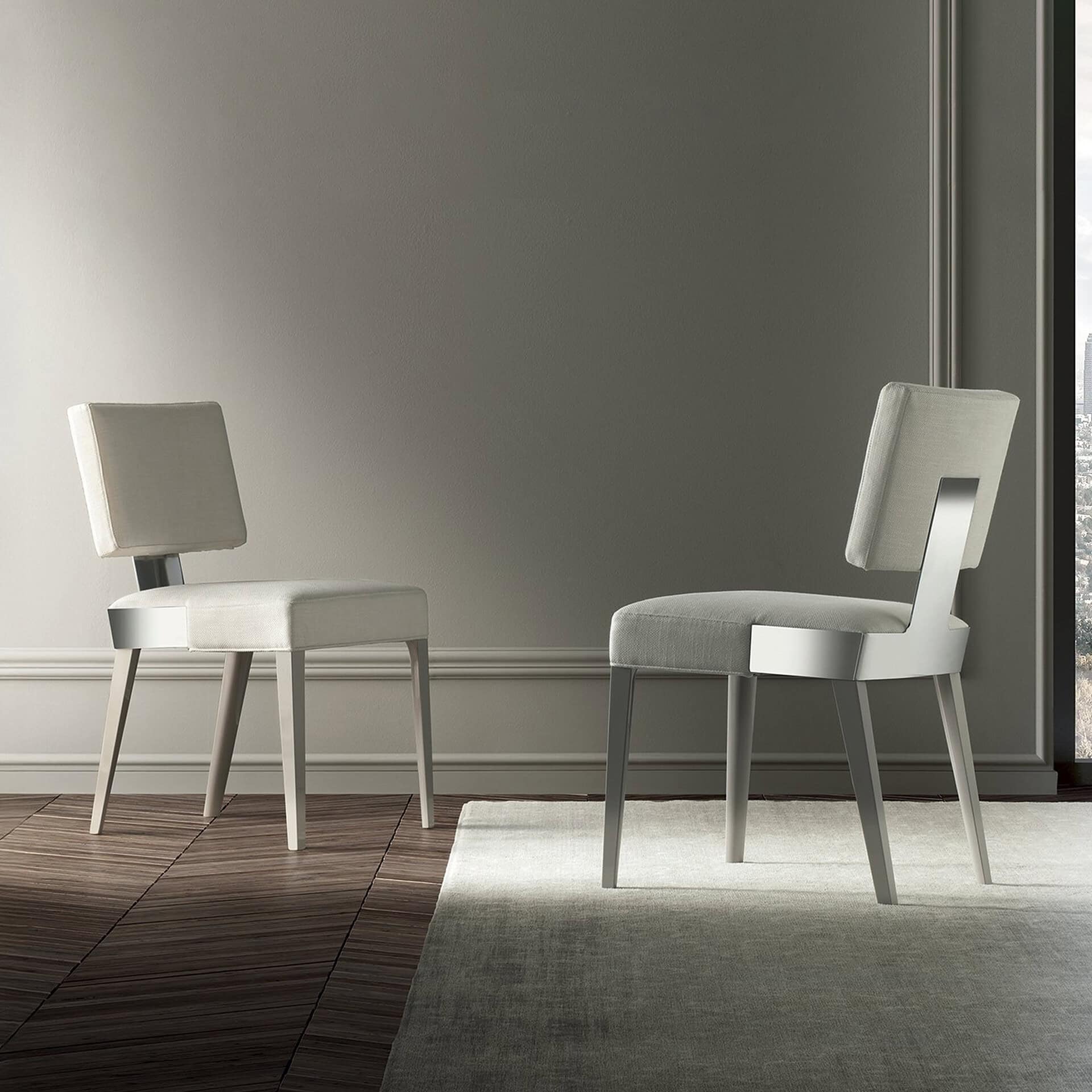 Elegant modern white dining chairs in a minimalist interior setting.