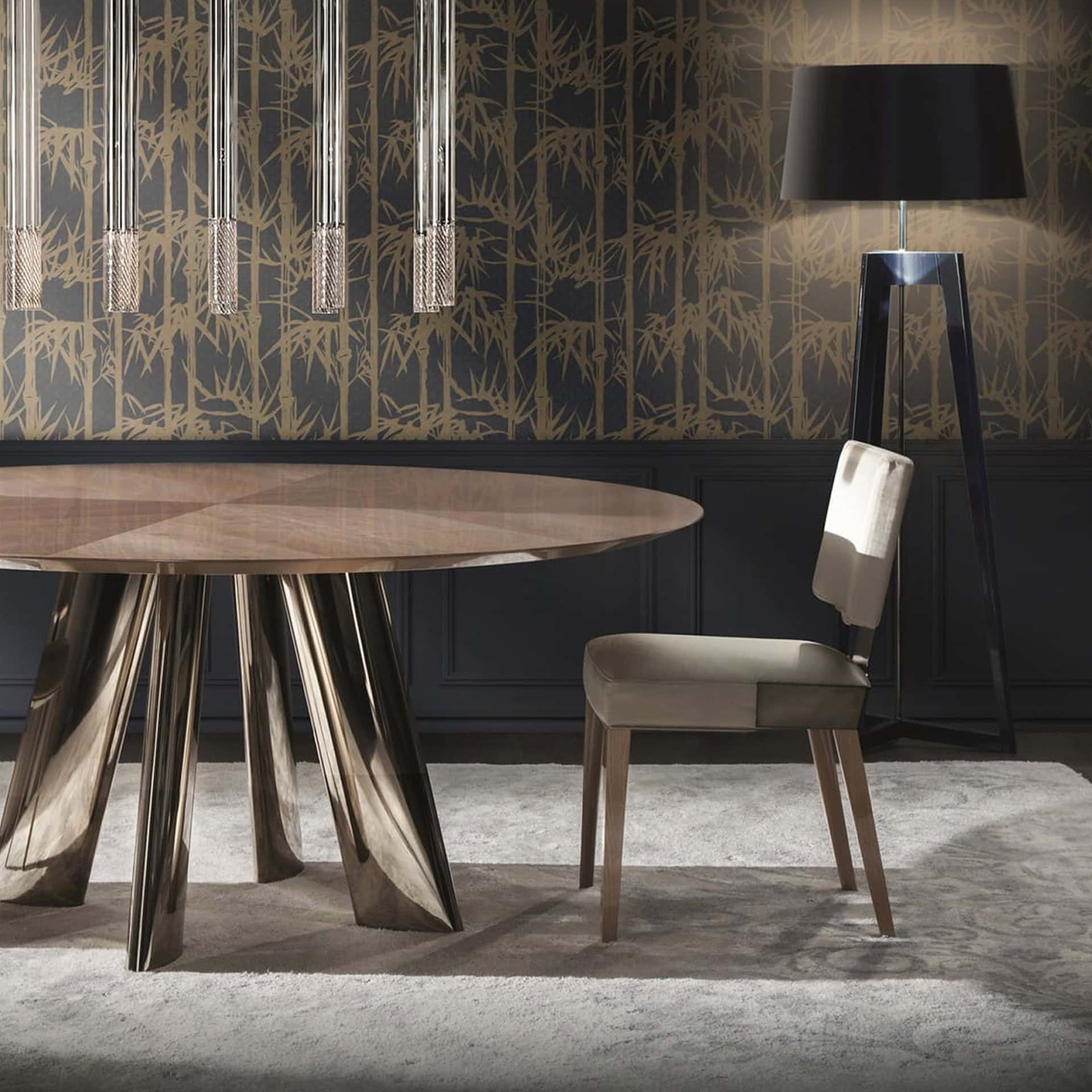 Elegant dining room featuring a stylish round table, upholstered chair, and contemporary lighting fi.