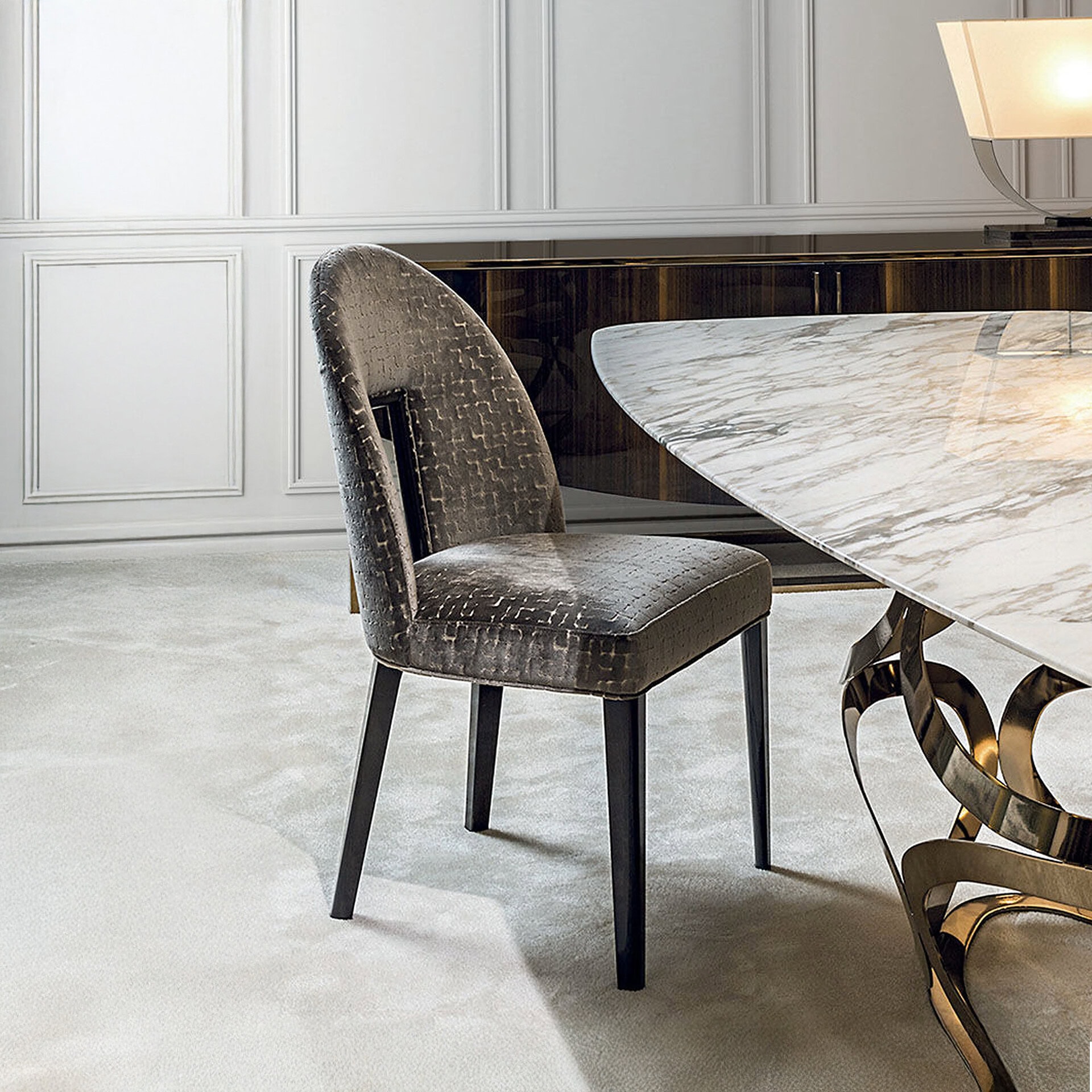 Modern upholstered dining chair with black wooden legs in elegant dining room setting.