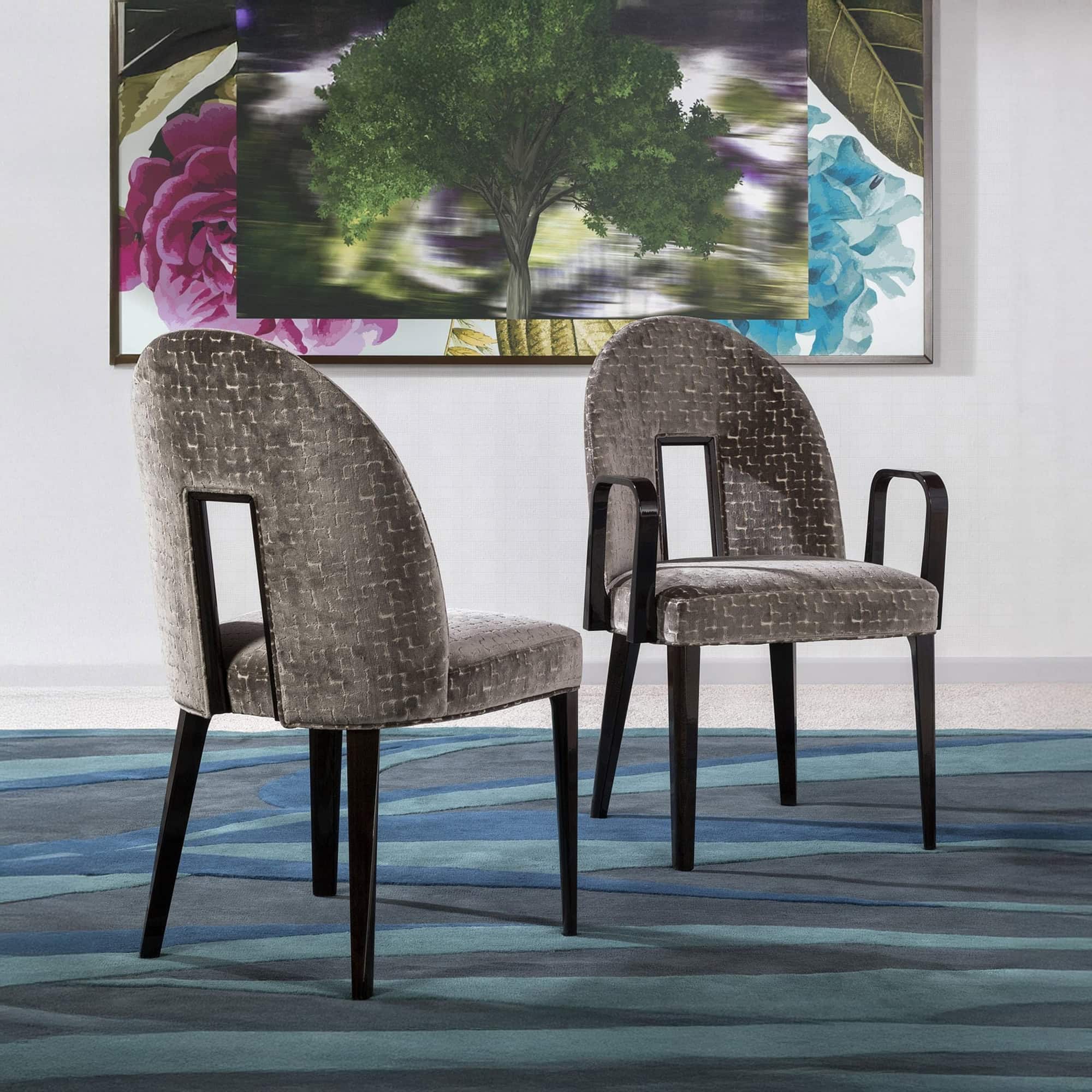 Upholstered dining chairs with armrests, dark wood legs, in a contemporary setting.