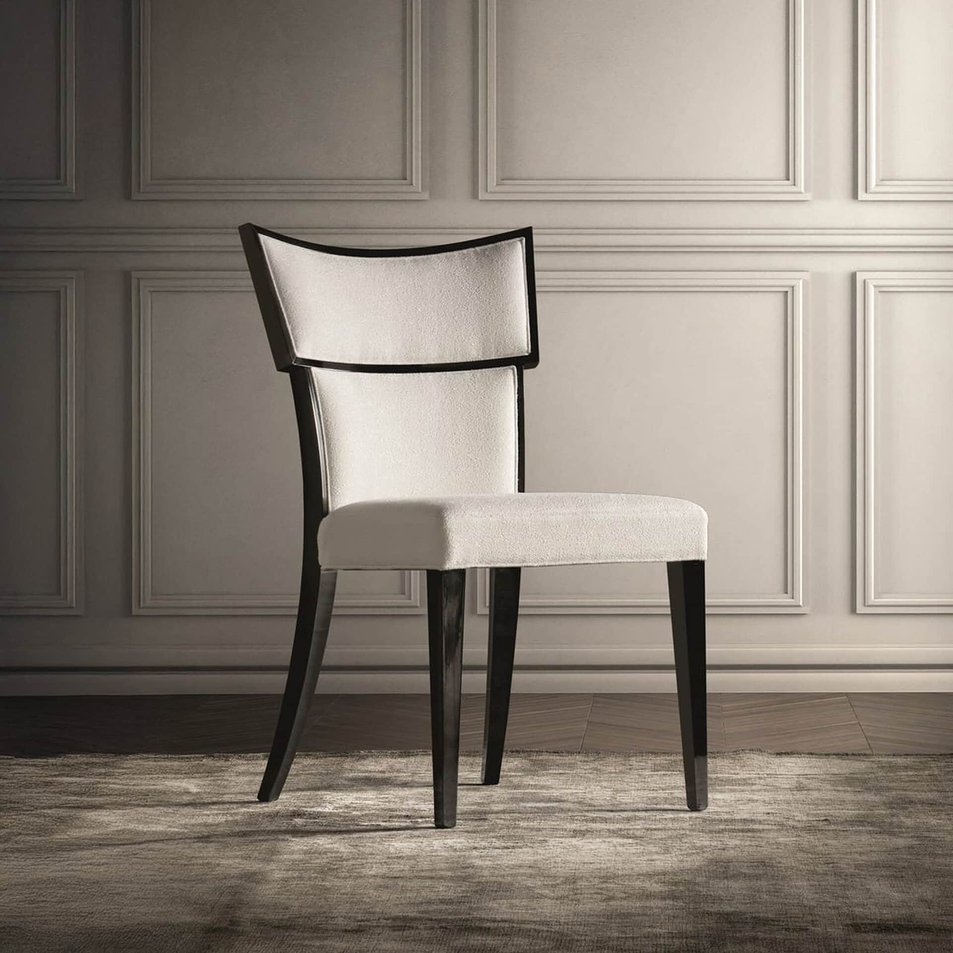 Luxury dining chair with cream fabric and dark wooden frame, perfect for sophisticated interiors.