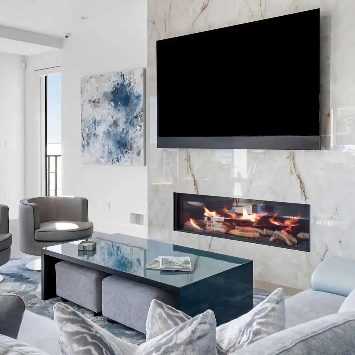 a living room with a fireplace and a tv