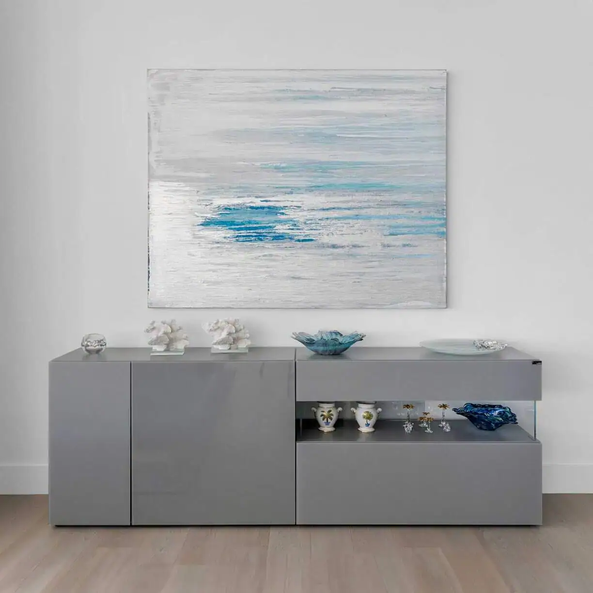 a grey cabinet with a painting on the wall