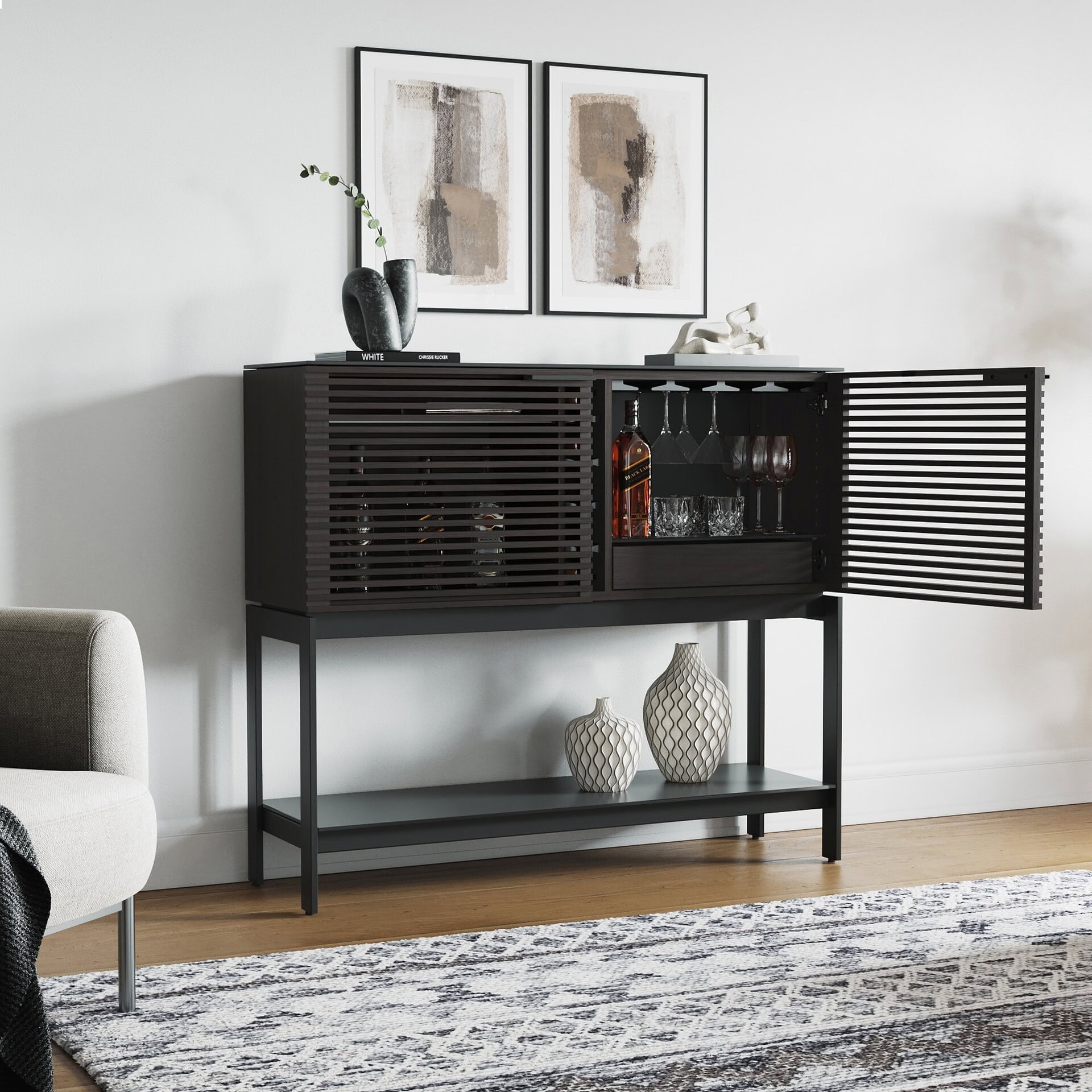 Sleek black modern bar cabinet with slatted doors, glassware, and decorative accents.