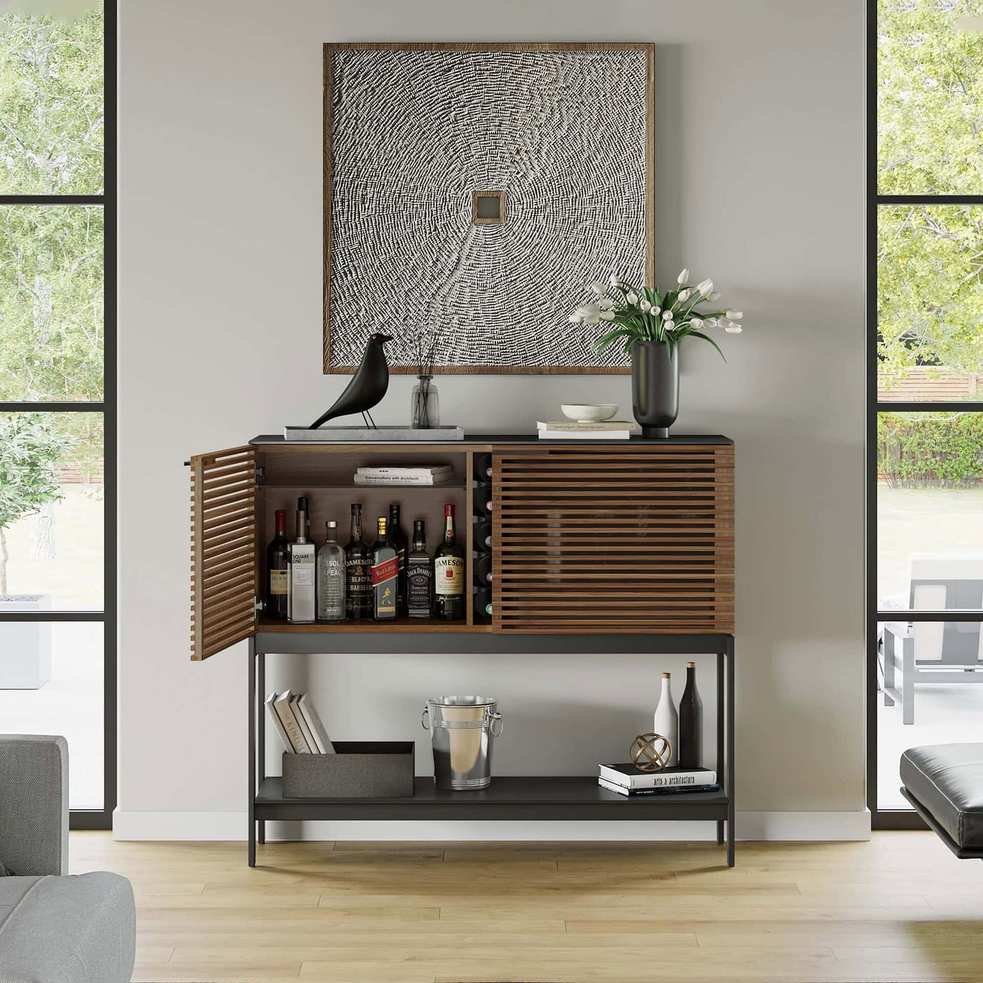 Contemporary wooden bar cabinet with slatted doors, decorative accessories, and art piece backdrop.