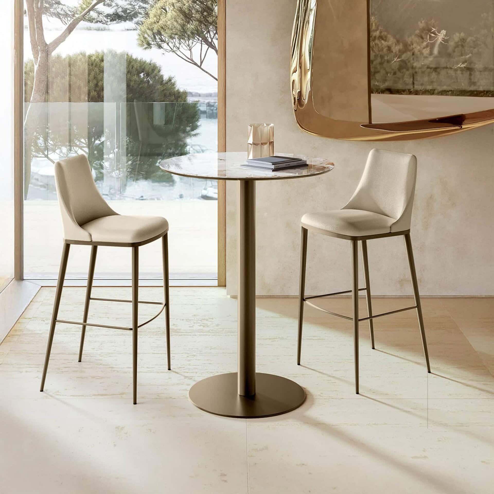 Cilindro Bistro Table with bronze base and wood top paired with counter stools.