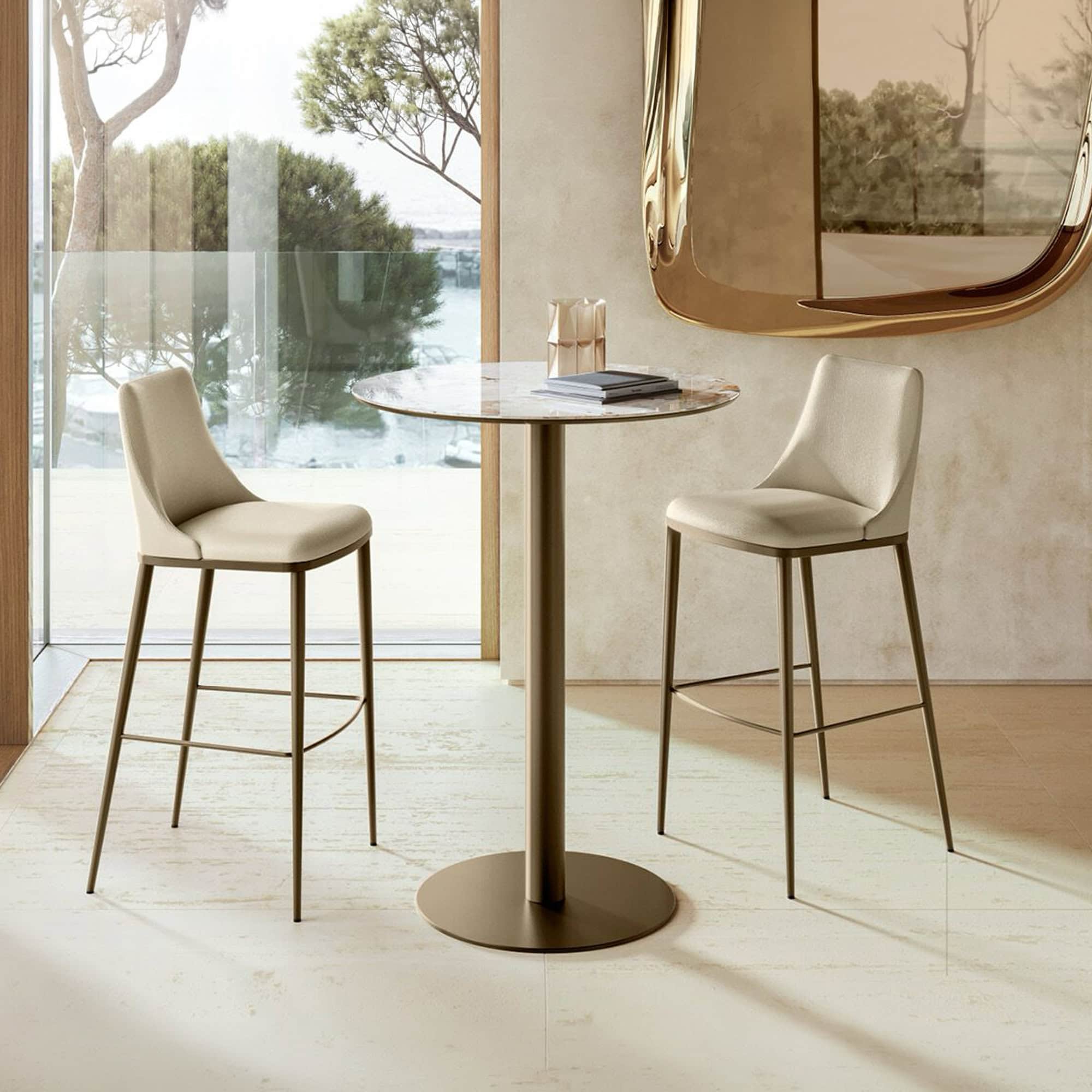 Cilindro Bistro Table with bronze base and wood top paired with counter stools.