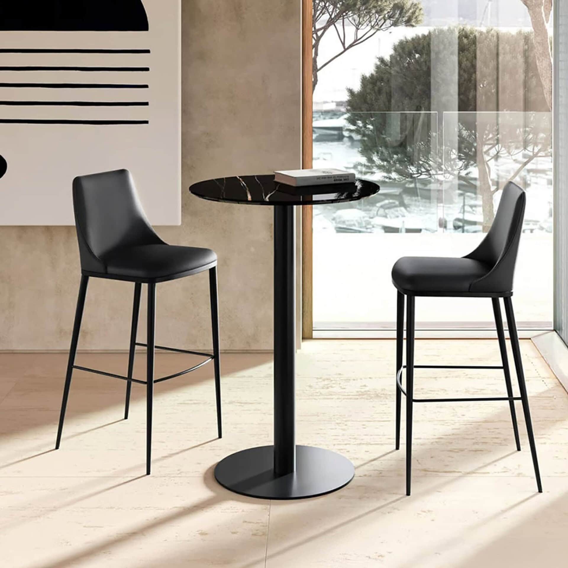 Cilindro Bistro Table with black base and round wood top in a contemporary dining space.