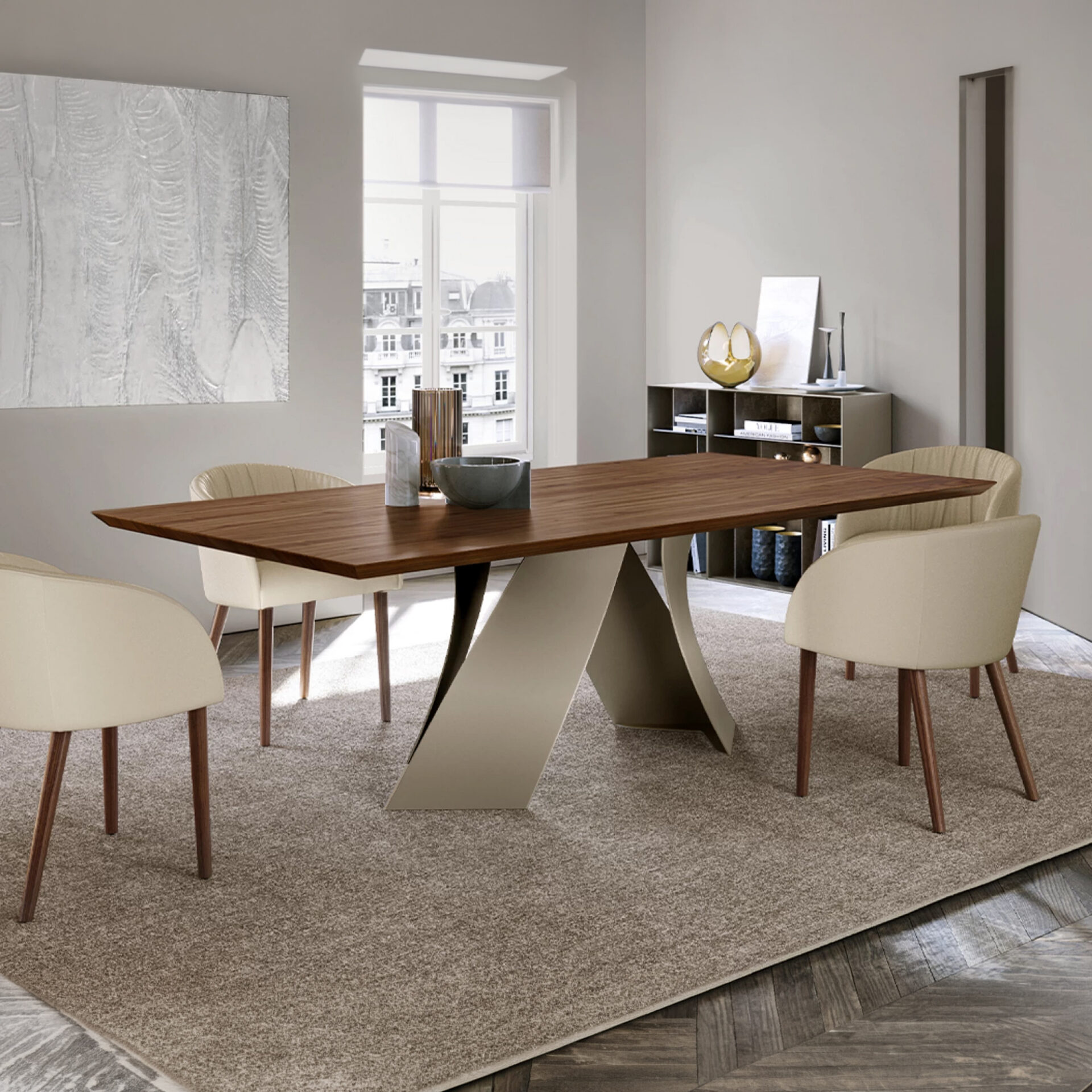 A modern dining room with a dark wood table, sculptural base, and cream chairs on a light brown rug. A large window overlooks a city, and abstract art adorns the wall.