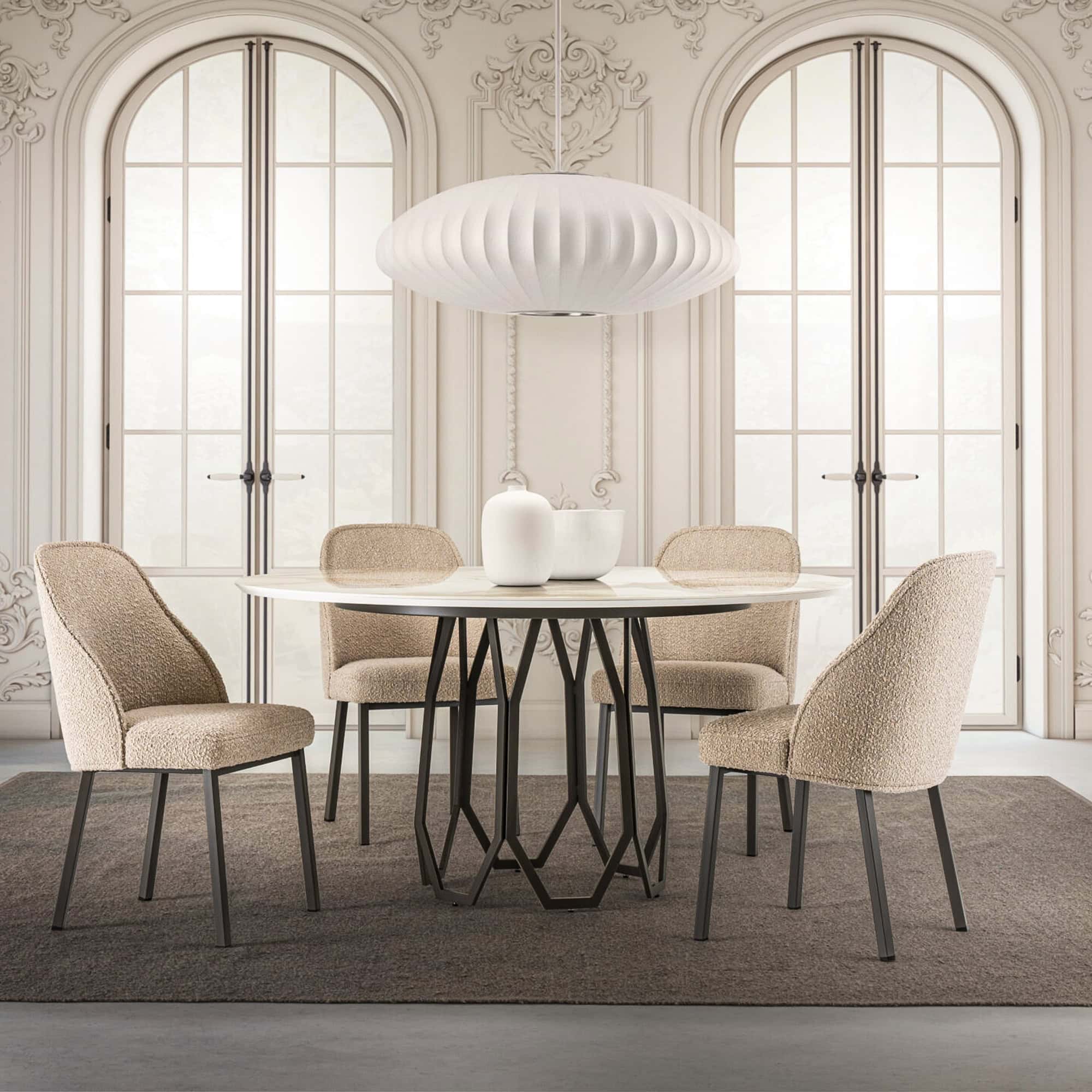 Round Opal Geometric Dining Table with a black sculptural metal base and white top, styled in a classic dining room with arched windows and upholstered chairs.
