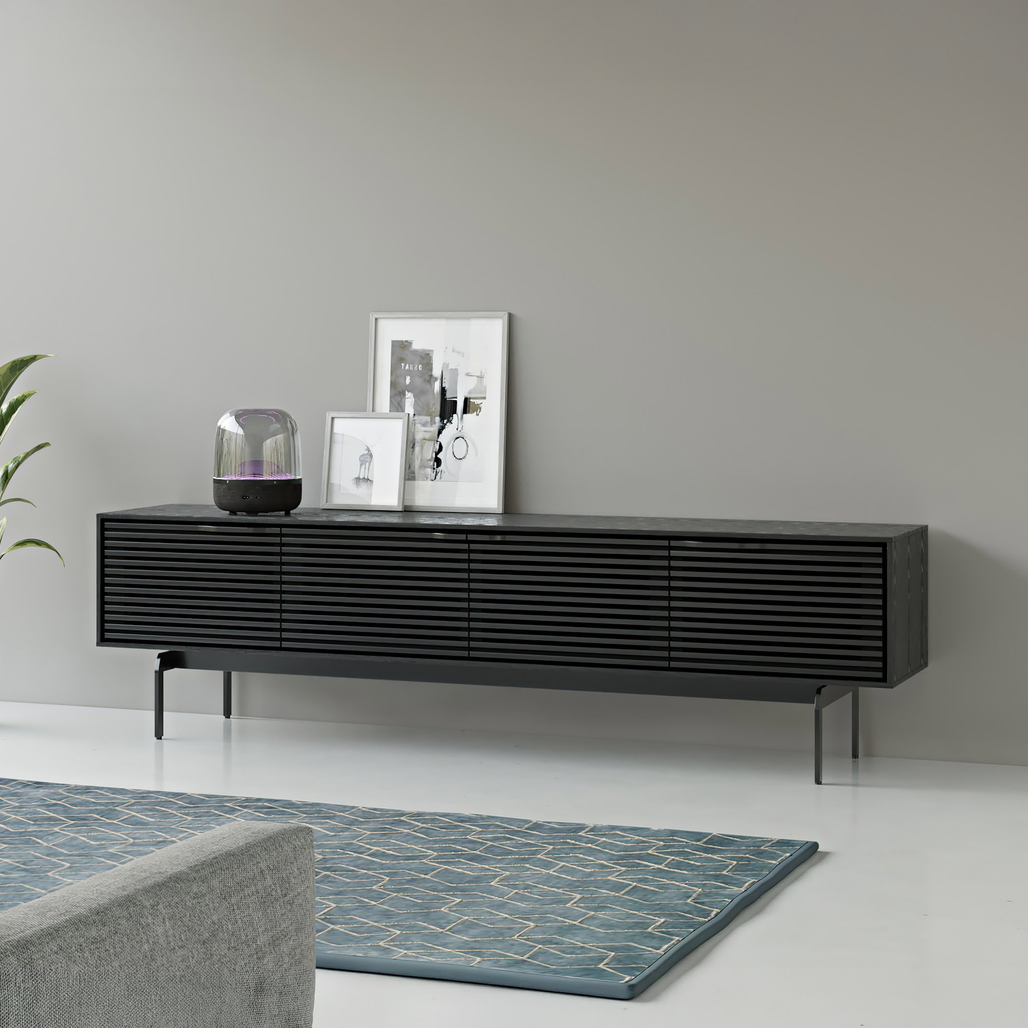 Sleek black modern media console with slatted design, perfect for contemporary living rooms.
