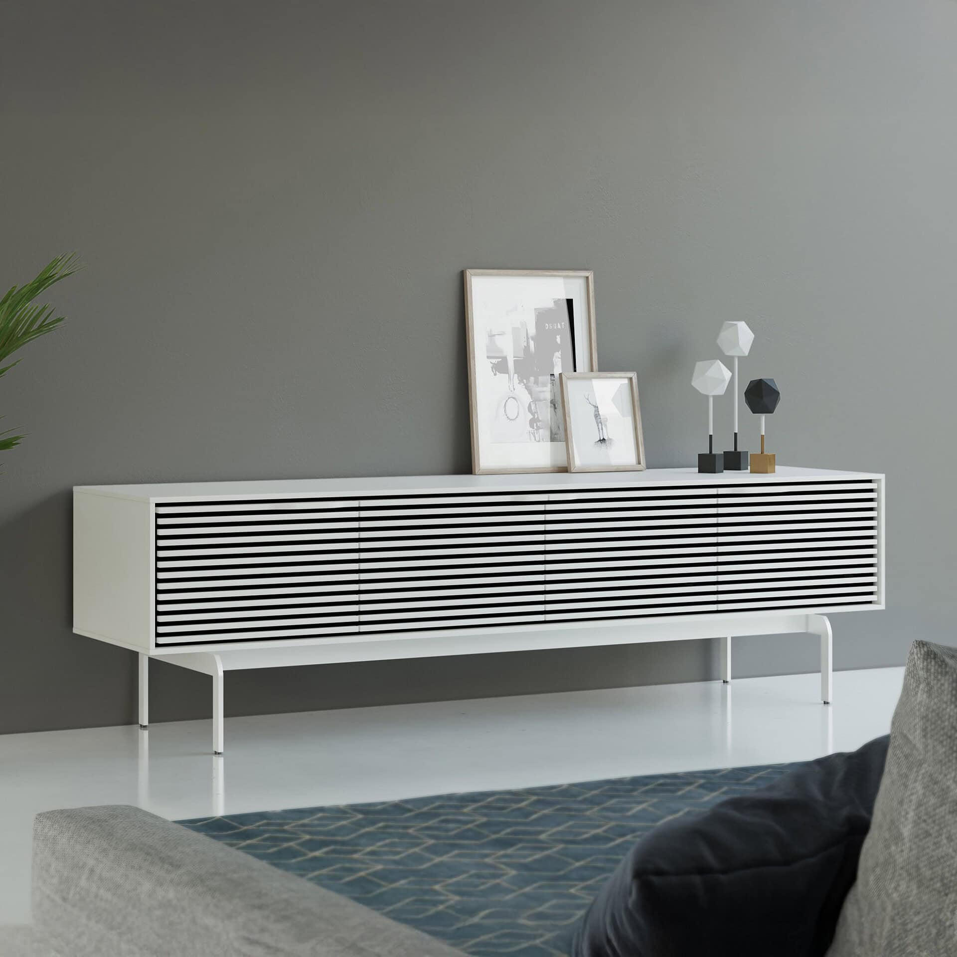 Modern sleek white media console with black slatted doors for stylish storage and decor.