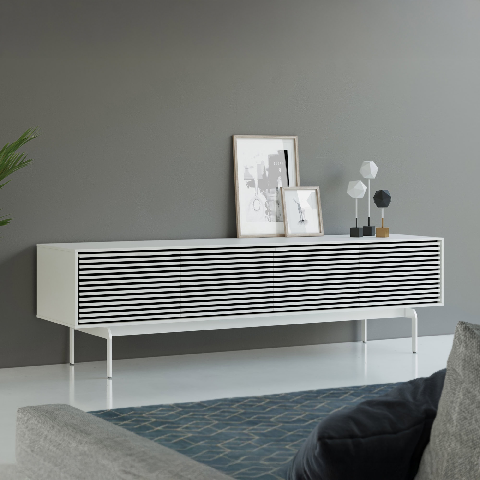 Modern sleek white media console with black slatted doors for stylish storage and decor.