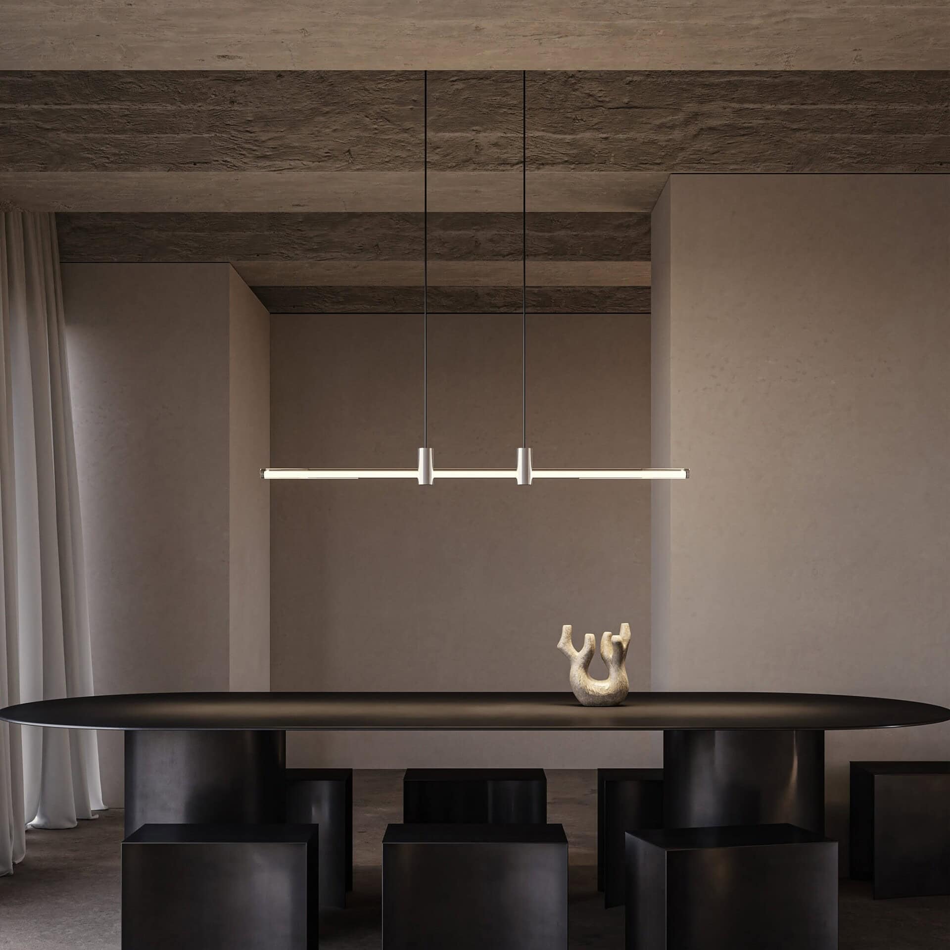 Sleek modern dining room with minimalist black table and matching ottomans, illuminated by contemporary pendant lighting.