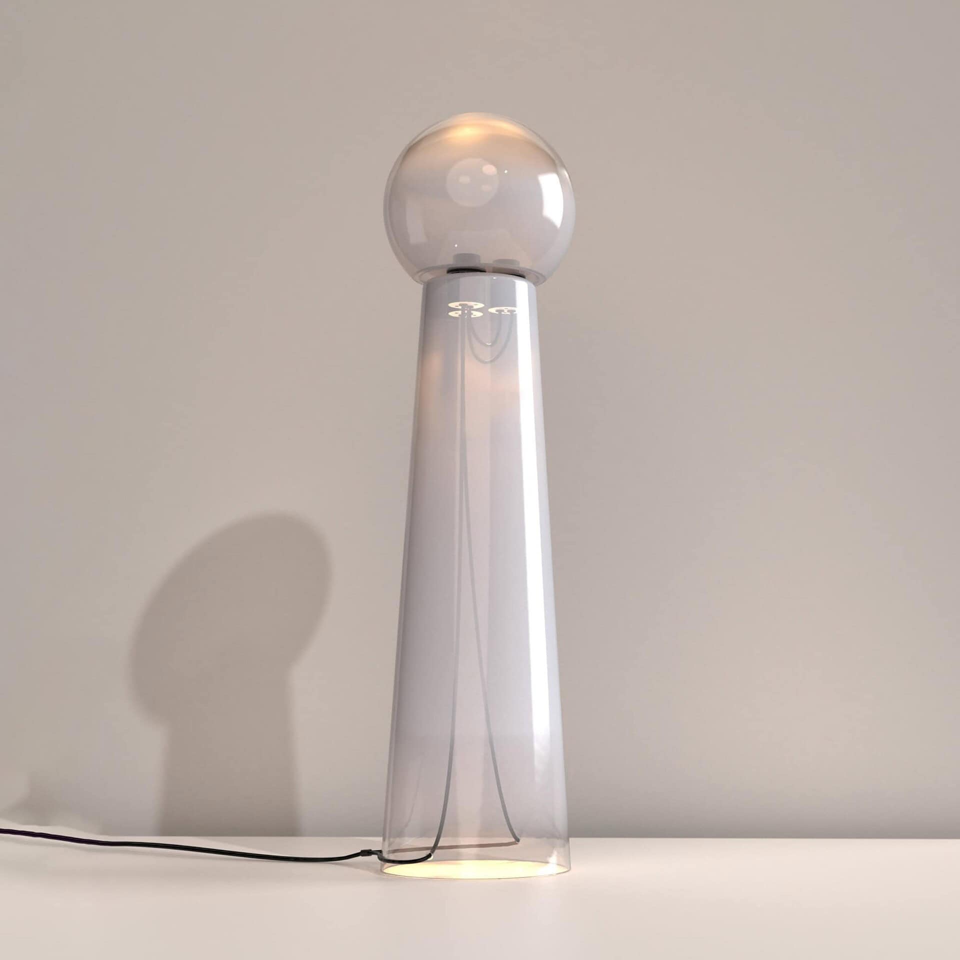 Modern crystal table lamp with transparent glass shade and sleek white base, perfect for contemporary home decor.