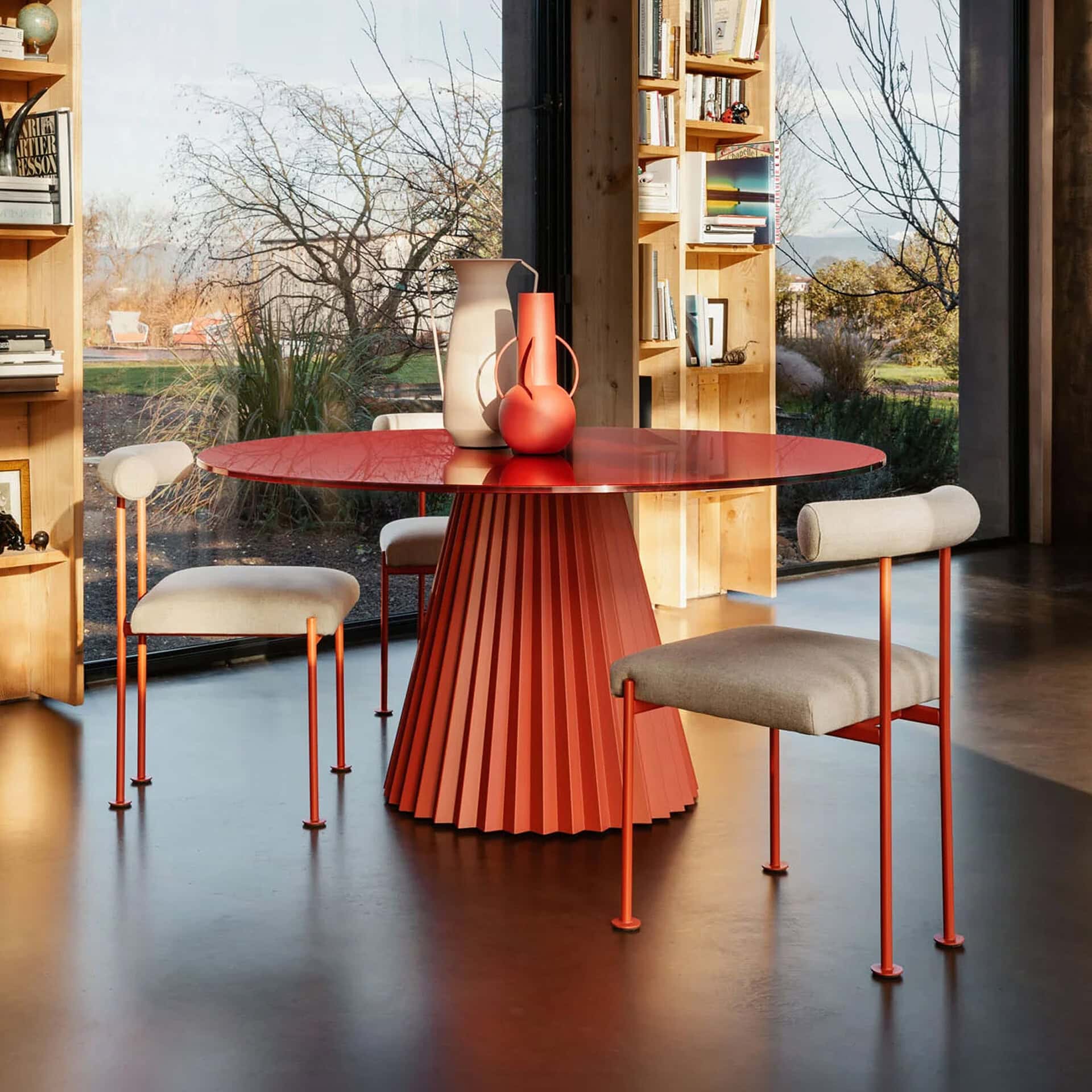 Modern Plissé Round Dining Table with vibrant red finish.