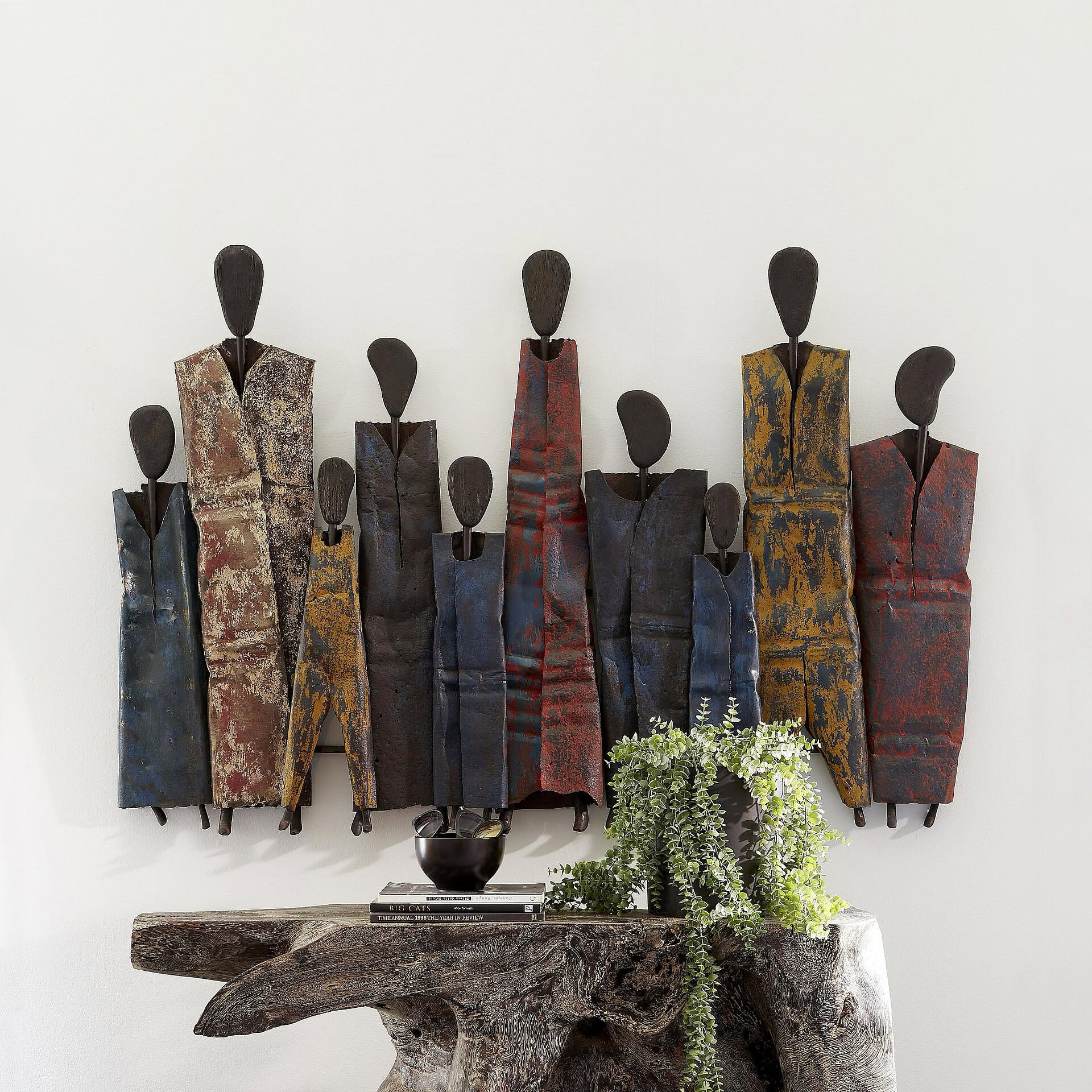 Decorative metal wall art featuring abstract honey drum figures for modern interior design.