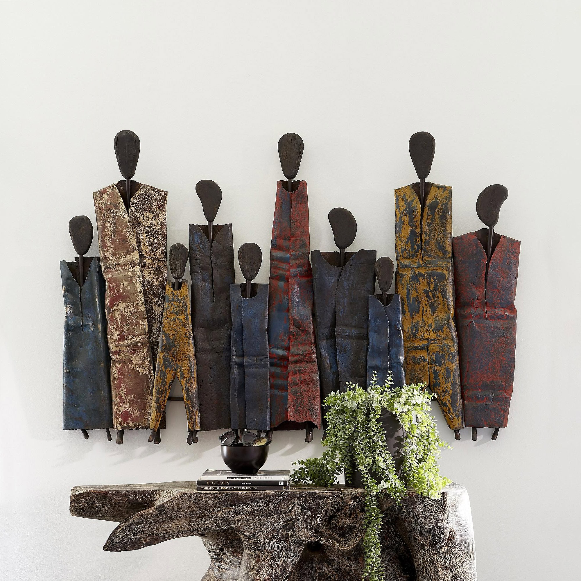 Decorative metal wall art featuring abstract honey drum figures for modern interior design.