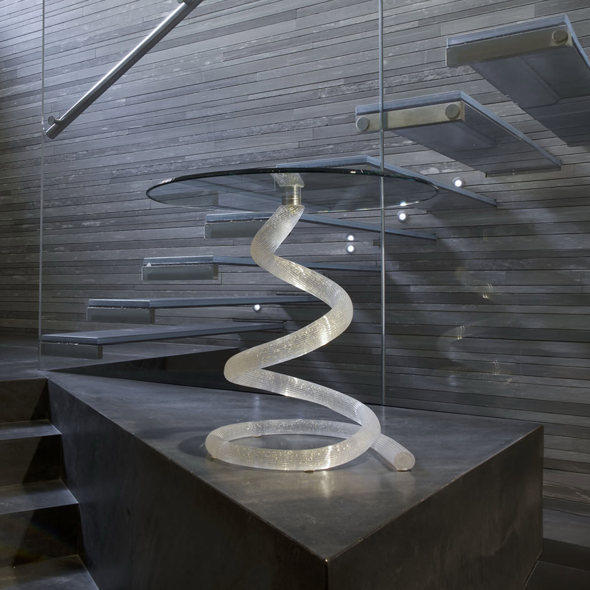 Sculptural Ghibli 55 side table with a spiral glass base and round glass top, modern design for styl.