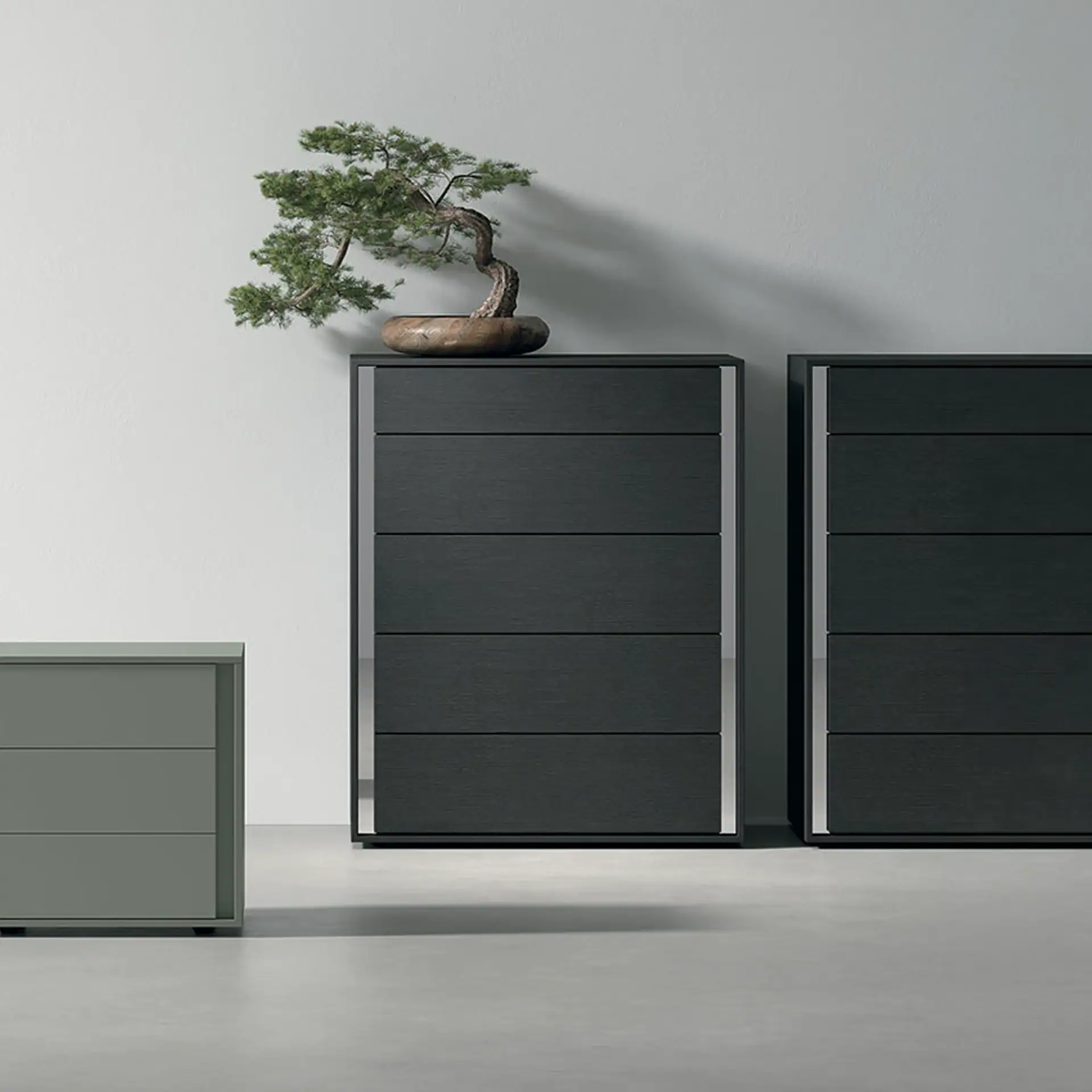 Modern black dressers with minimalist bonsai tree on top, sleek furniture for contemporary interiors.