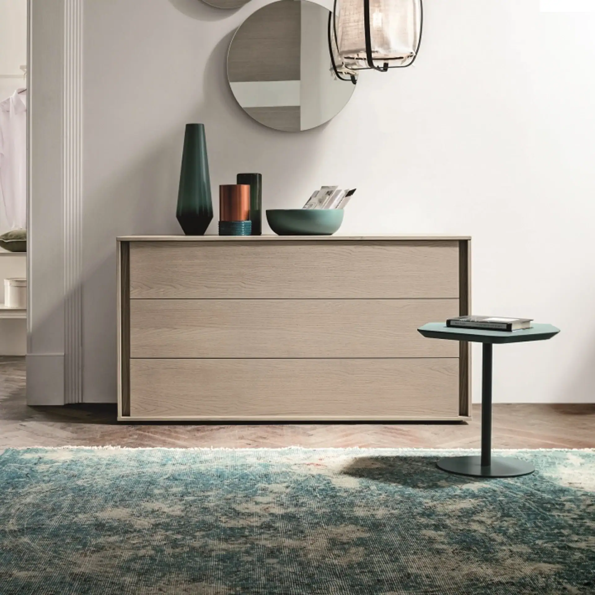 Modern minimalist dresser with decorative vases and mirror.