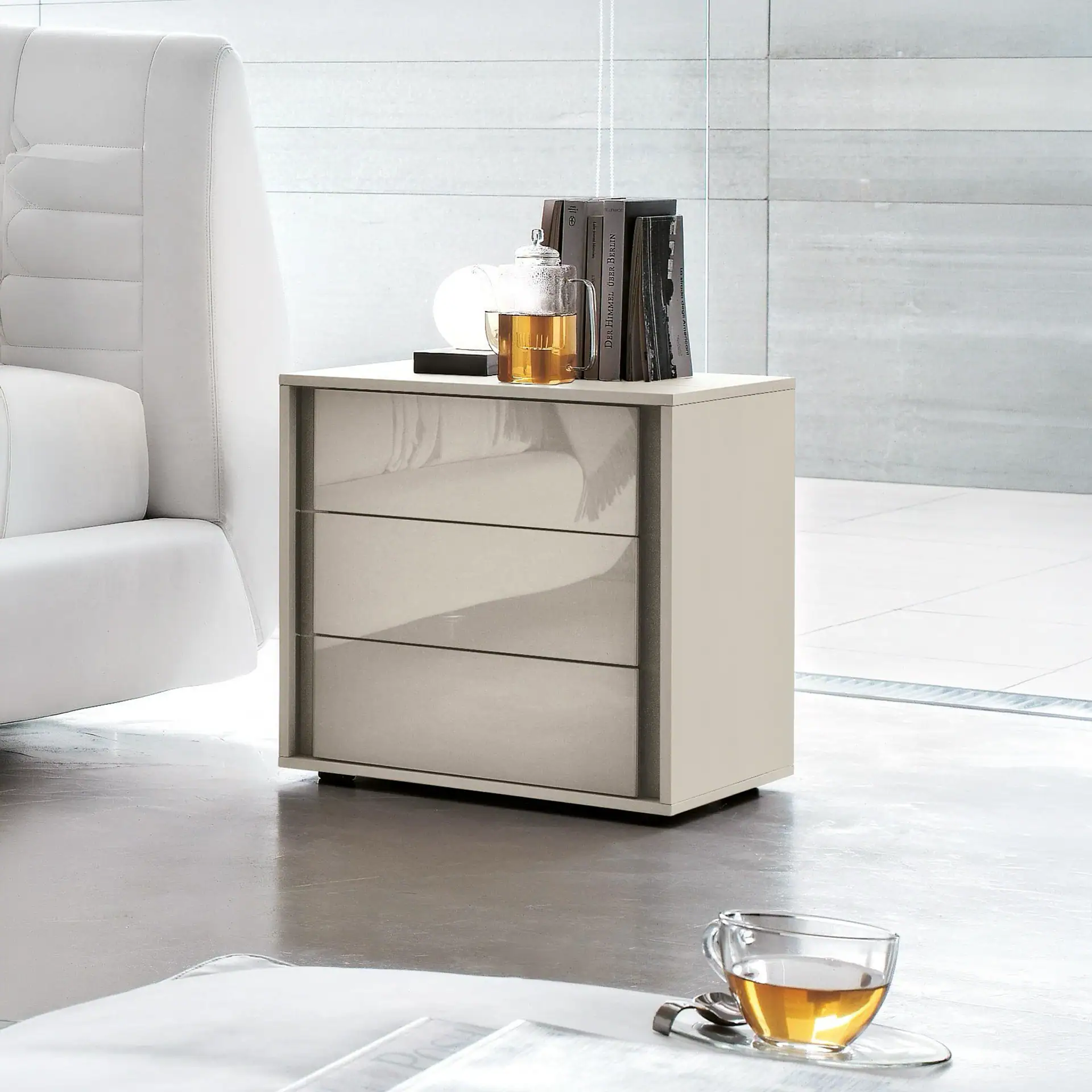 Modern white nightstand with three drawers, ideal for bedroom storage and decor.
