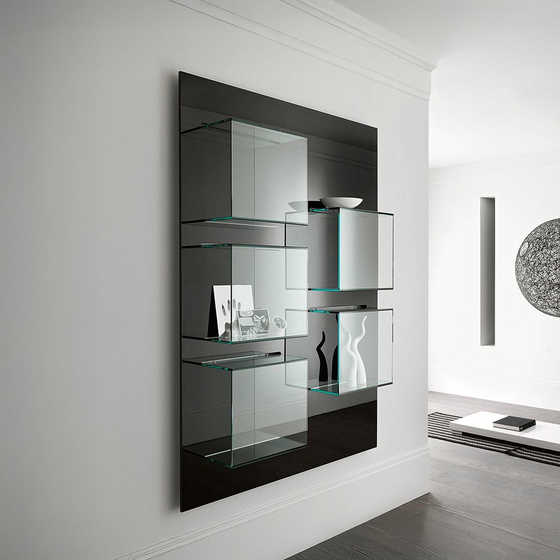 Tonelli Dazibao Bookcase in extra clear glass with matt black panel, vertical version shown in a contemporary interior.