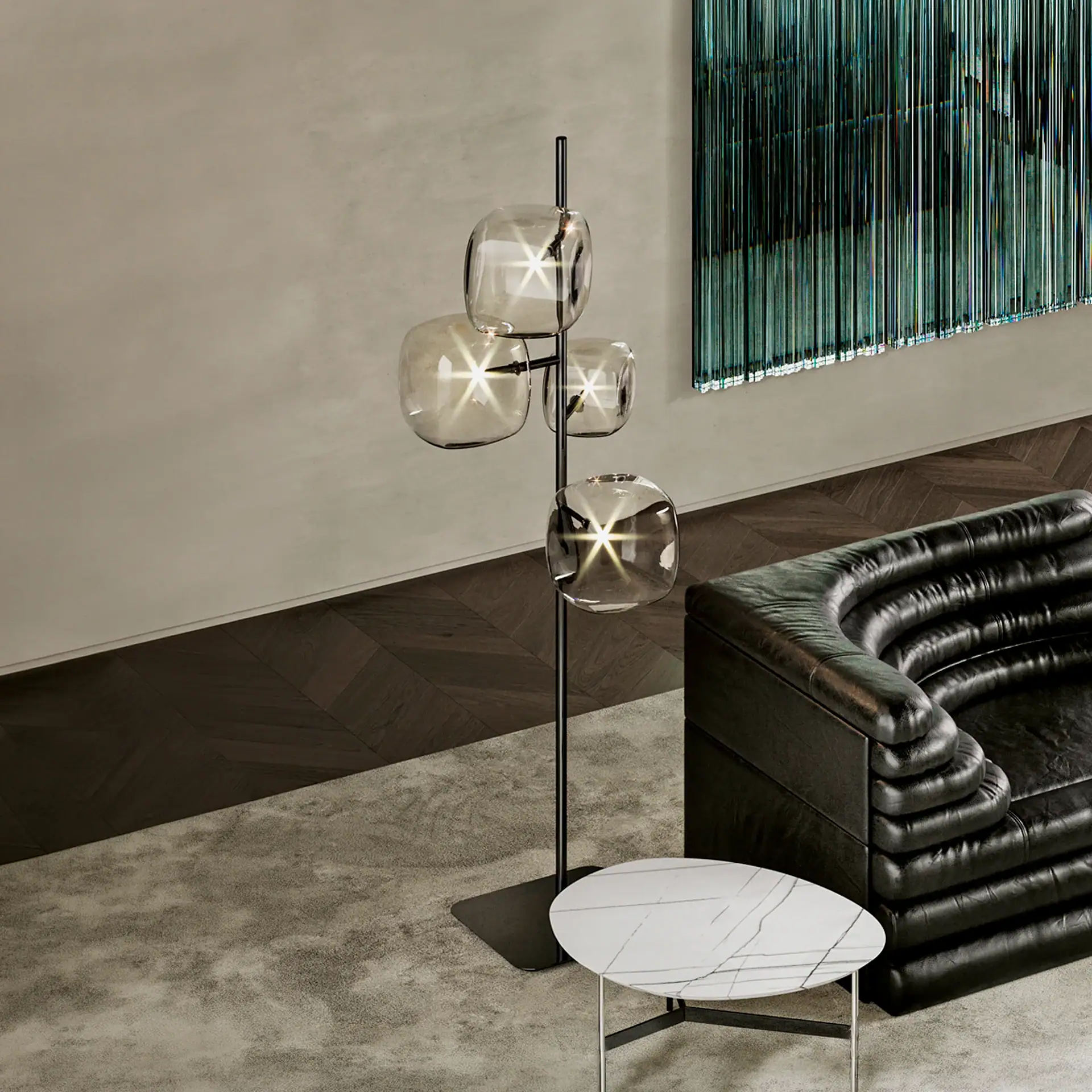 Contemporary glass and metal floor lamp with three spherical glass shades in a stylish living room.