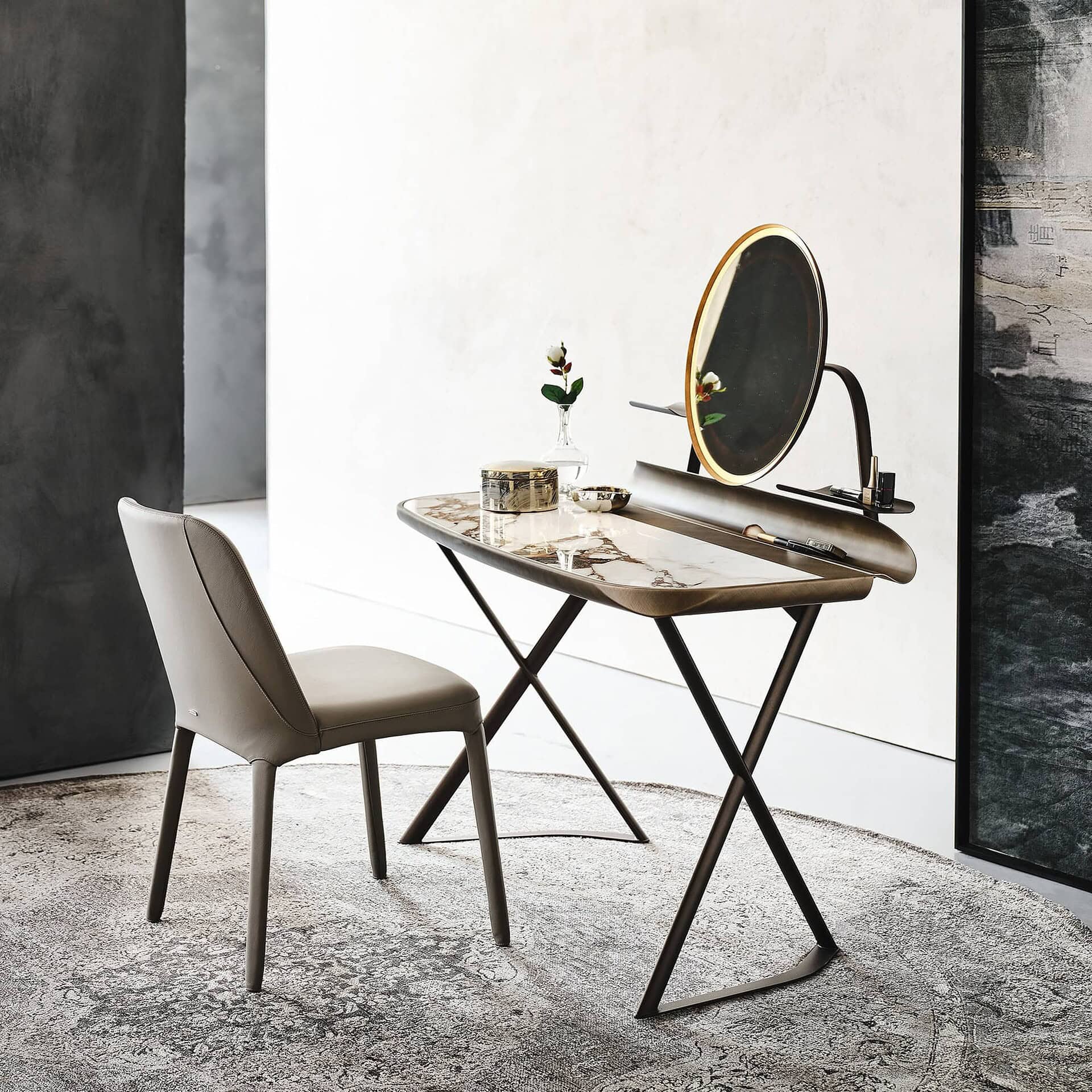 Vanity desk with ceramic top and round mirror paired with an upholstered chair in a modern bedroom setting.