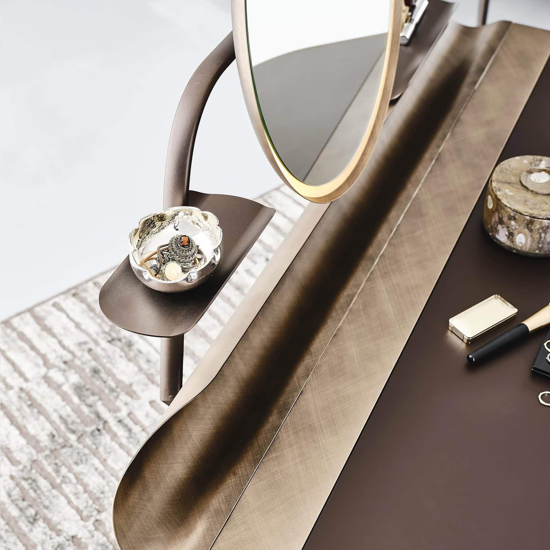Detail of leather-topped Cocoon Trousse vanity with accessories and circular mirror.